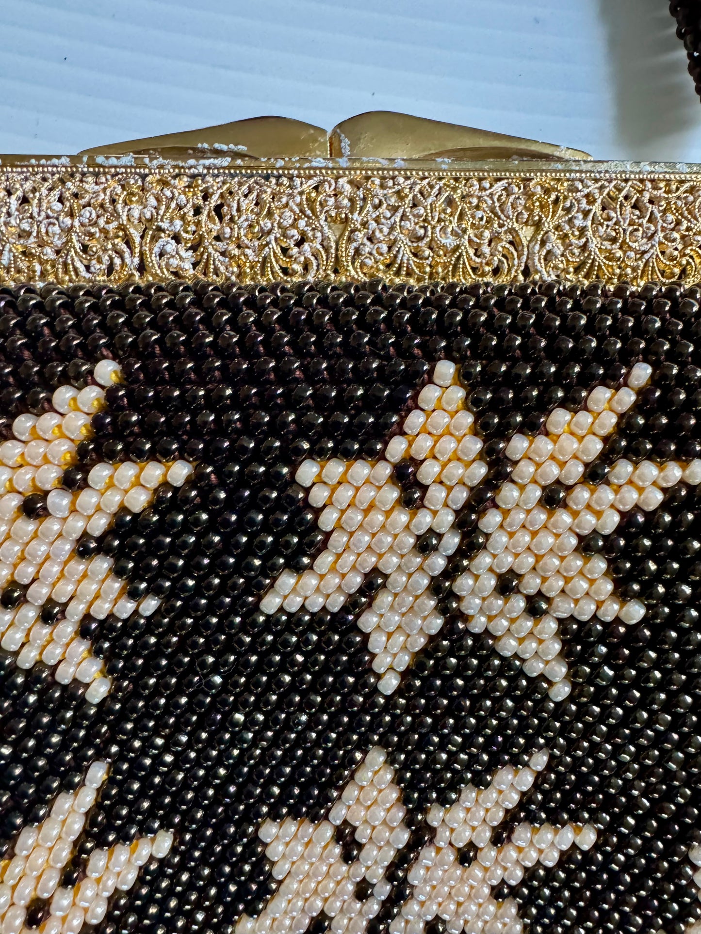 Beautiful 1940s beaded bag with brown and ivory beads, gold decorative hardware and beautiful interior. Sourced in Paris.