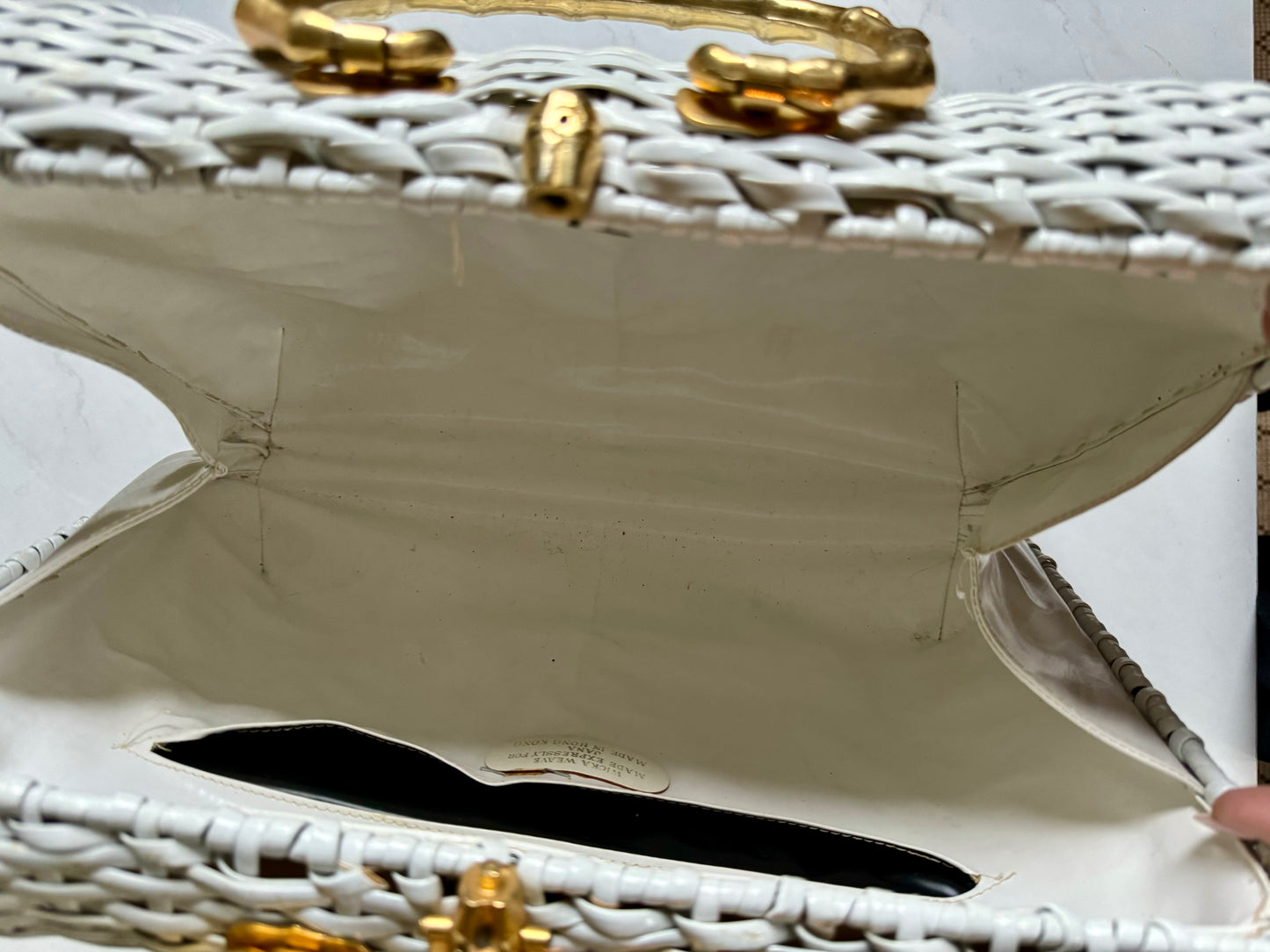 White woven handbag with bamboo gold tone handle