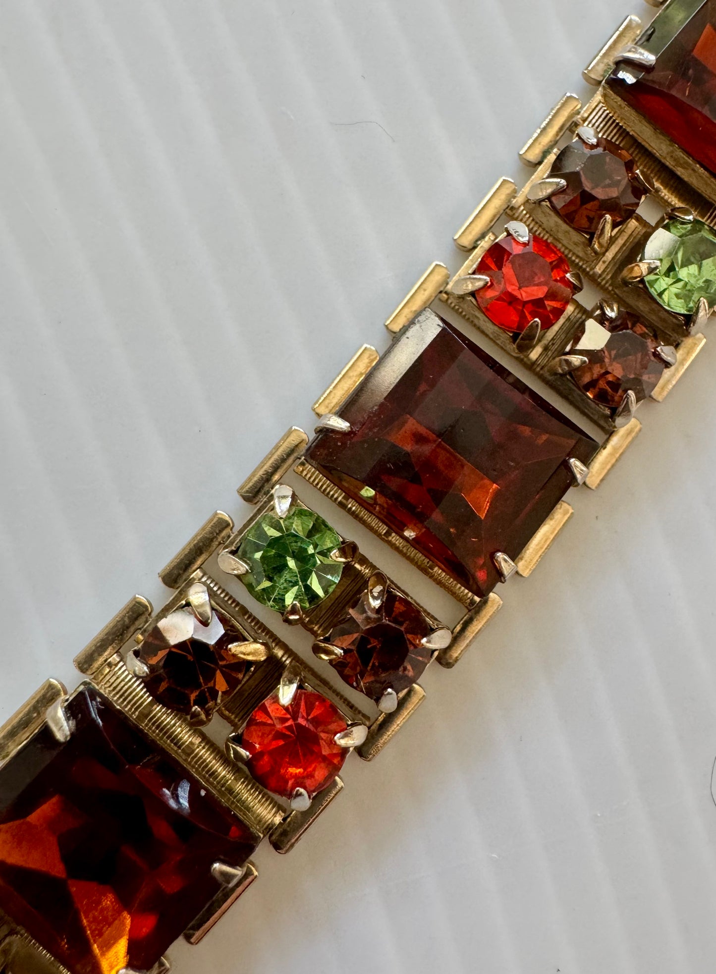 Beautiful vintage bracelet in gold tone with amber, orange and green rhinestones. Sourced in Paris.
