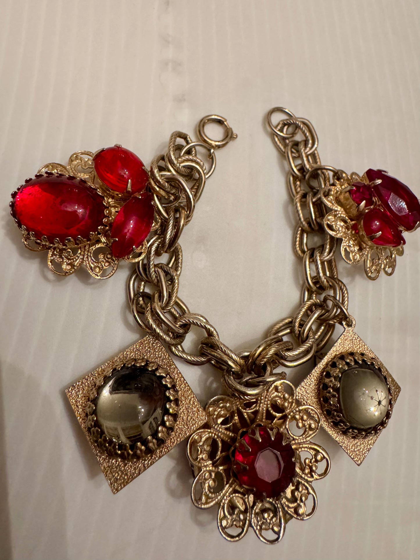 Wonderful RARE vintage double sided charm bracelet in gold tone with red stones and fabulous moonstones