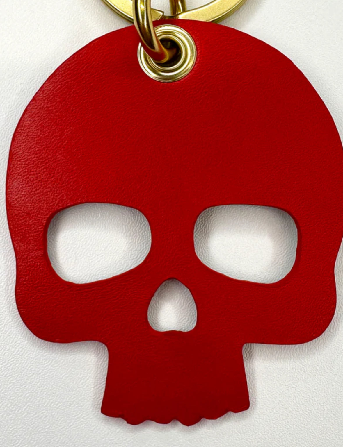 Upcycled authentic Louis Vuitton made into bag charms/key rings. Choose black or red backing. Brass hardware.