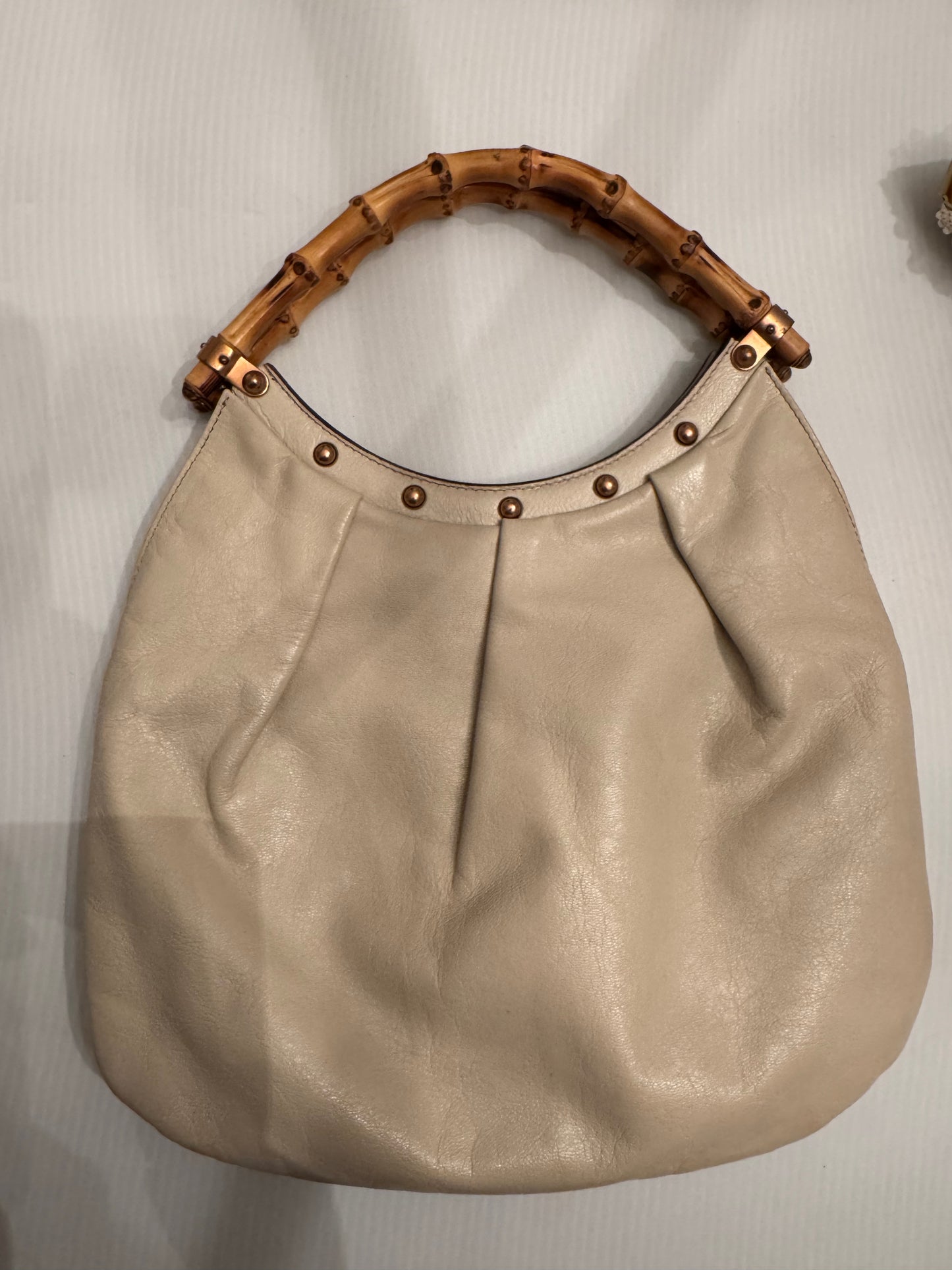 Vintage ivory leather GUCCI bag bronze studs and bamboo handle. Sourced in Palm Beach.