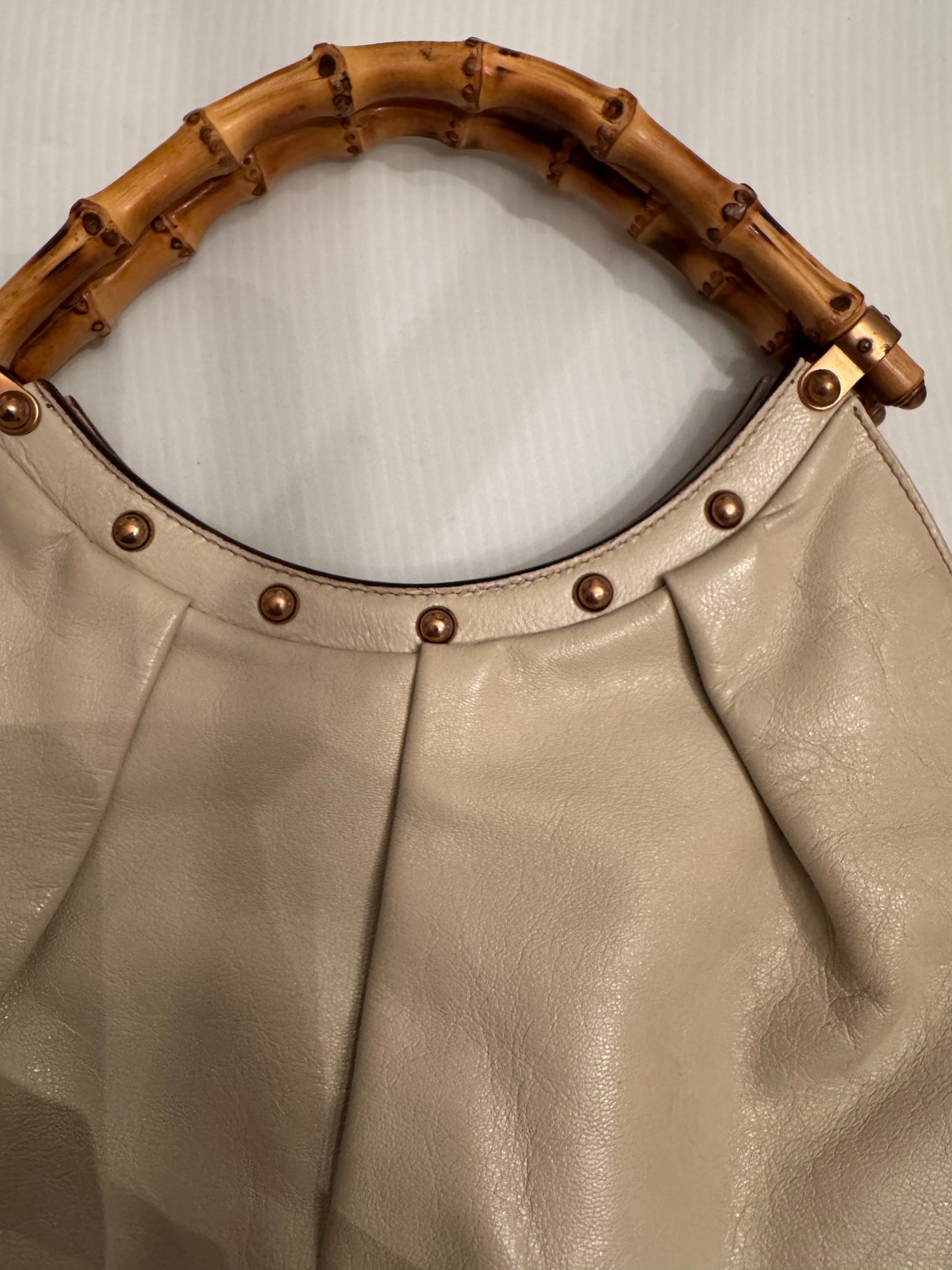 Vintage ivory leather GUCCI bag bronze studs and bamboo handle. Sourced in Palm Beach.