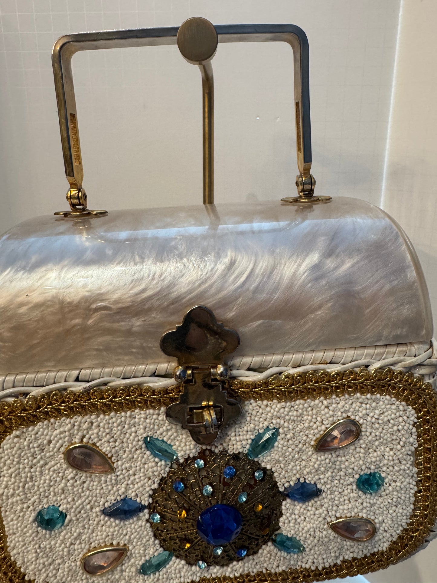 This top handle 1950s bag is a real showstopper. White wicker Lucite top square gold handle beads, and rhinestones in beautiful condition.