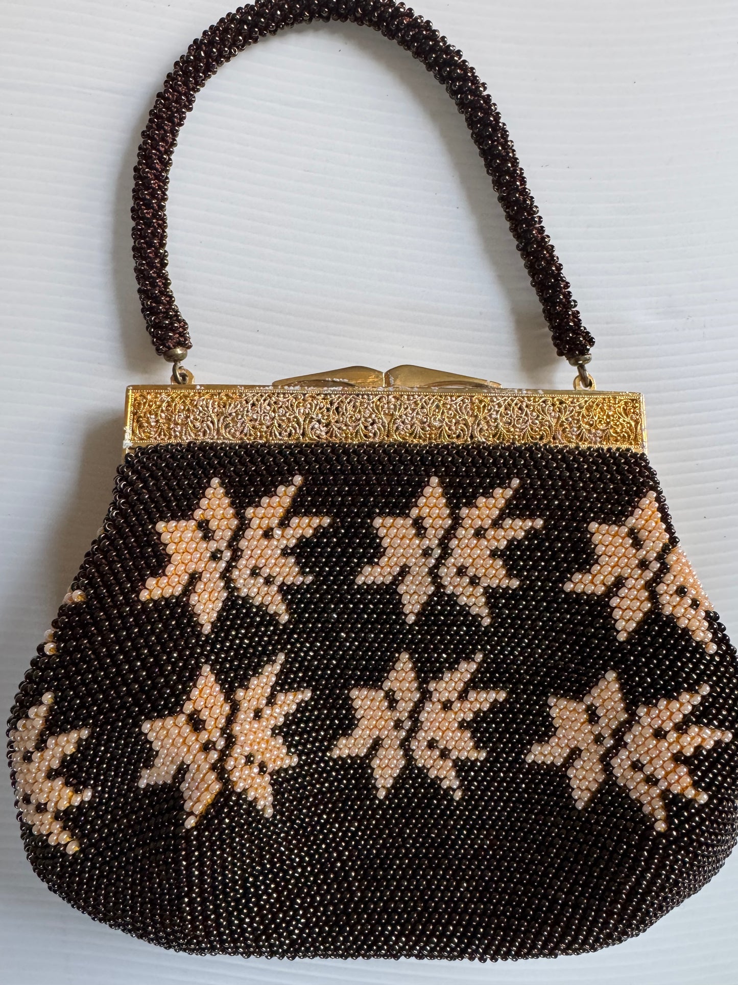 Beautiful 1940s beaded bag with brown and ivory beads, gold decorative hardware and beautiful interior. Sourced in Paris.