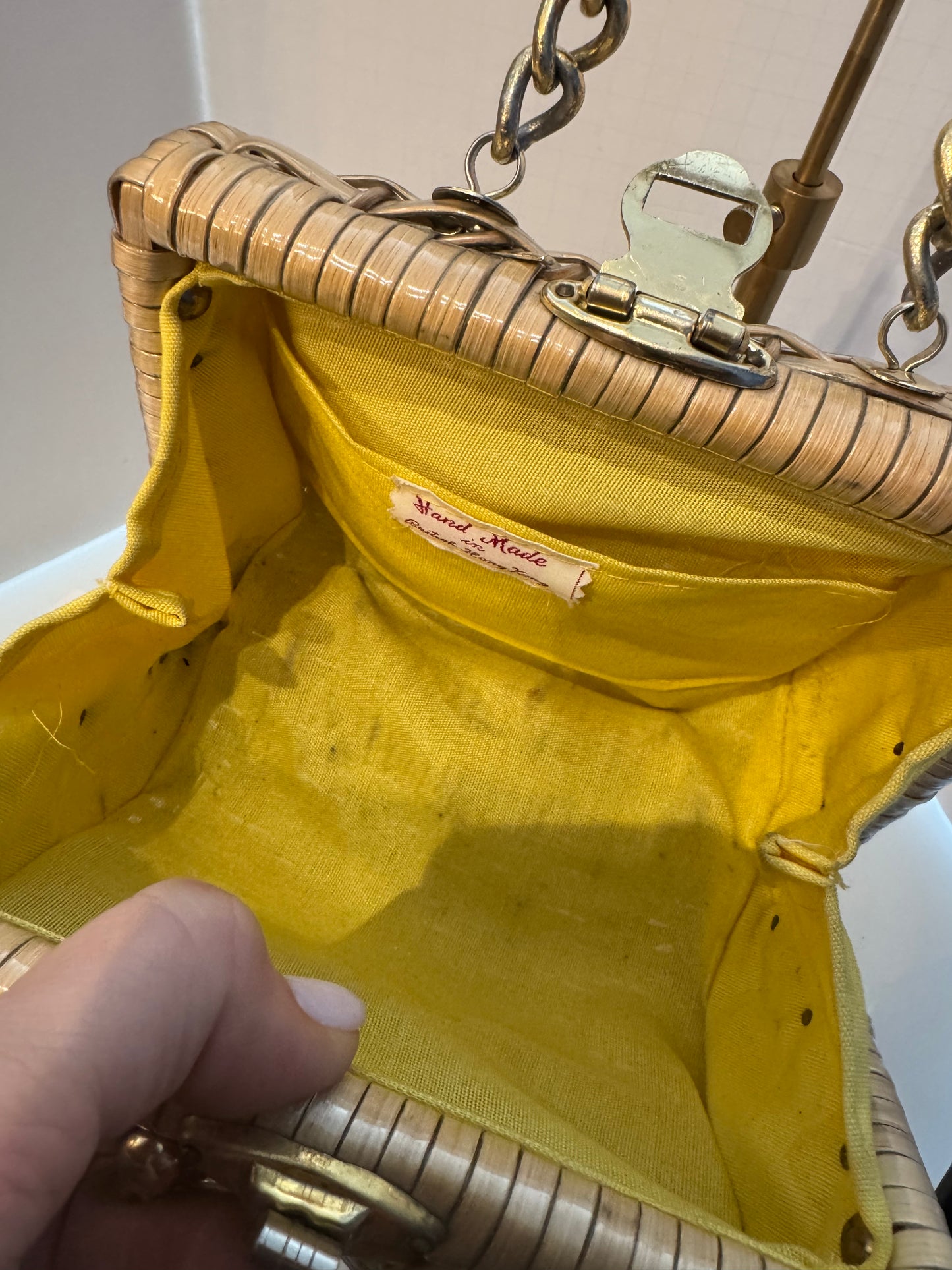 Beautiful 1950s wicker bag with gold chain decoration on front and gold hardware. Yellow fabric inside has some slight imperfection. Please see last photo Just a gorgeous piece.