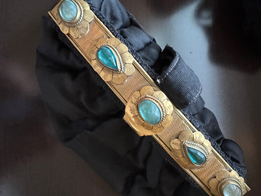 Stunning one of a kind 1920s black silk wristlet bag with decorative gold tone hardware and blue stones. A RARE collectors piece of history.
