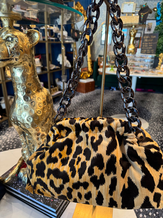 Exclusive Limited Edition Vavra New York bag collection. This  print leopard fabric (large print) bag converts from clutch to shoulder strap with chunky chain shown. Black lining with interior pocket.