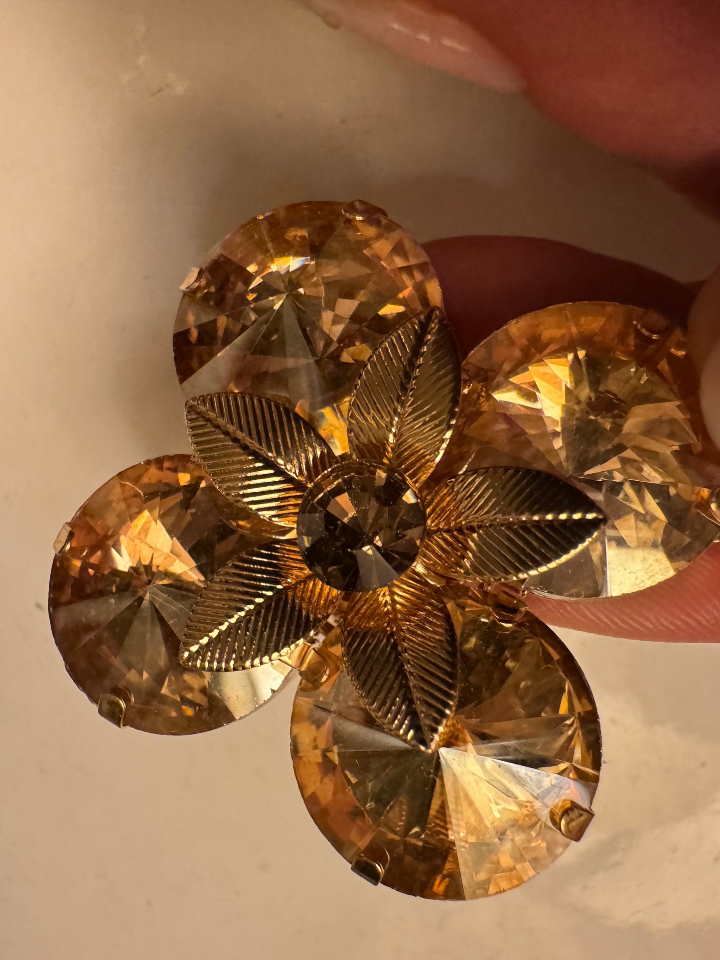 Beautiful 1980s rhinestone amber colored flowering with gold center flower. Sourced in Paris.