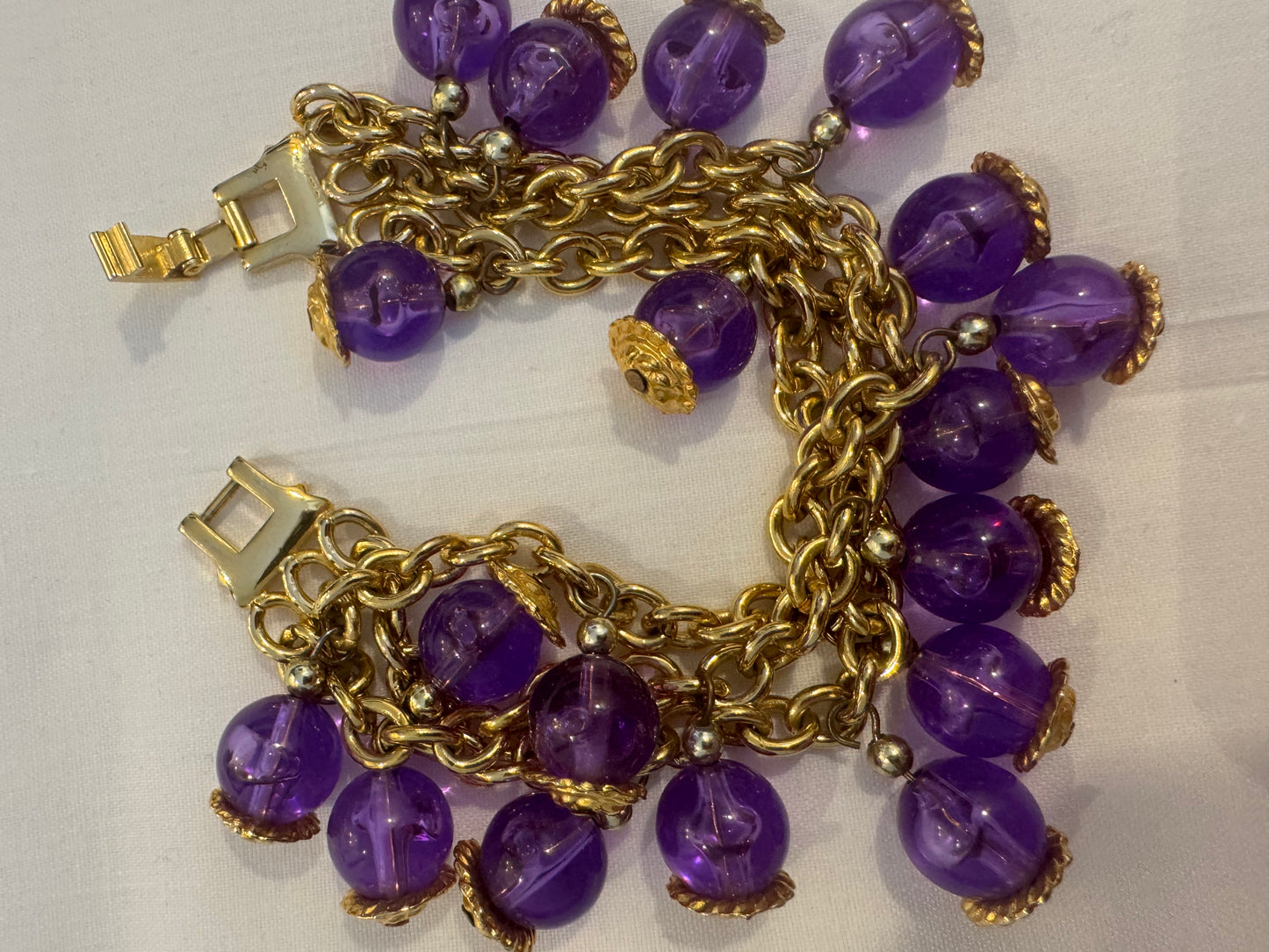 Beautiful gold tone, multi strand bracelet with purple stones. 1980s. Sourced in Paris.