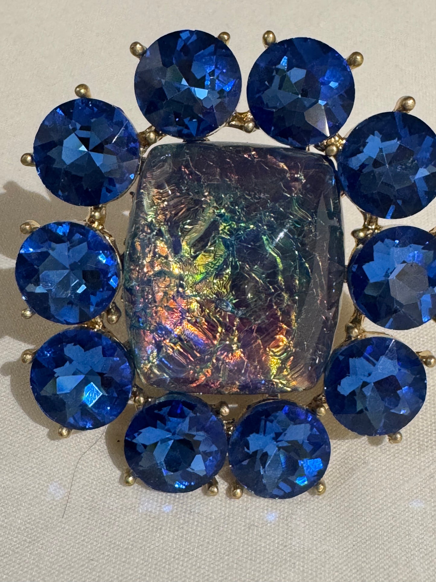 Jumbo 1980s cocktail ring with blue flower rhinestones and center multicolored stone. Sourced in Paris.