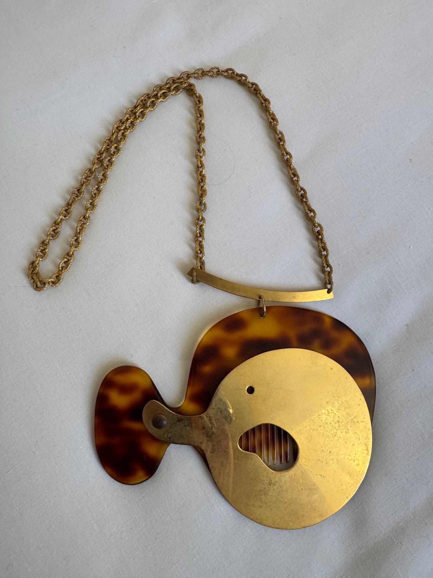 What a wonderful, crazy 1960s vintage piece found at the Paris flea market. It's a necklace with a jumbo tortoise comb and a sculptural gold tone cover. Sourced in Paris.