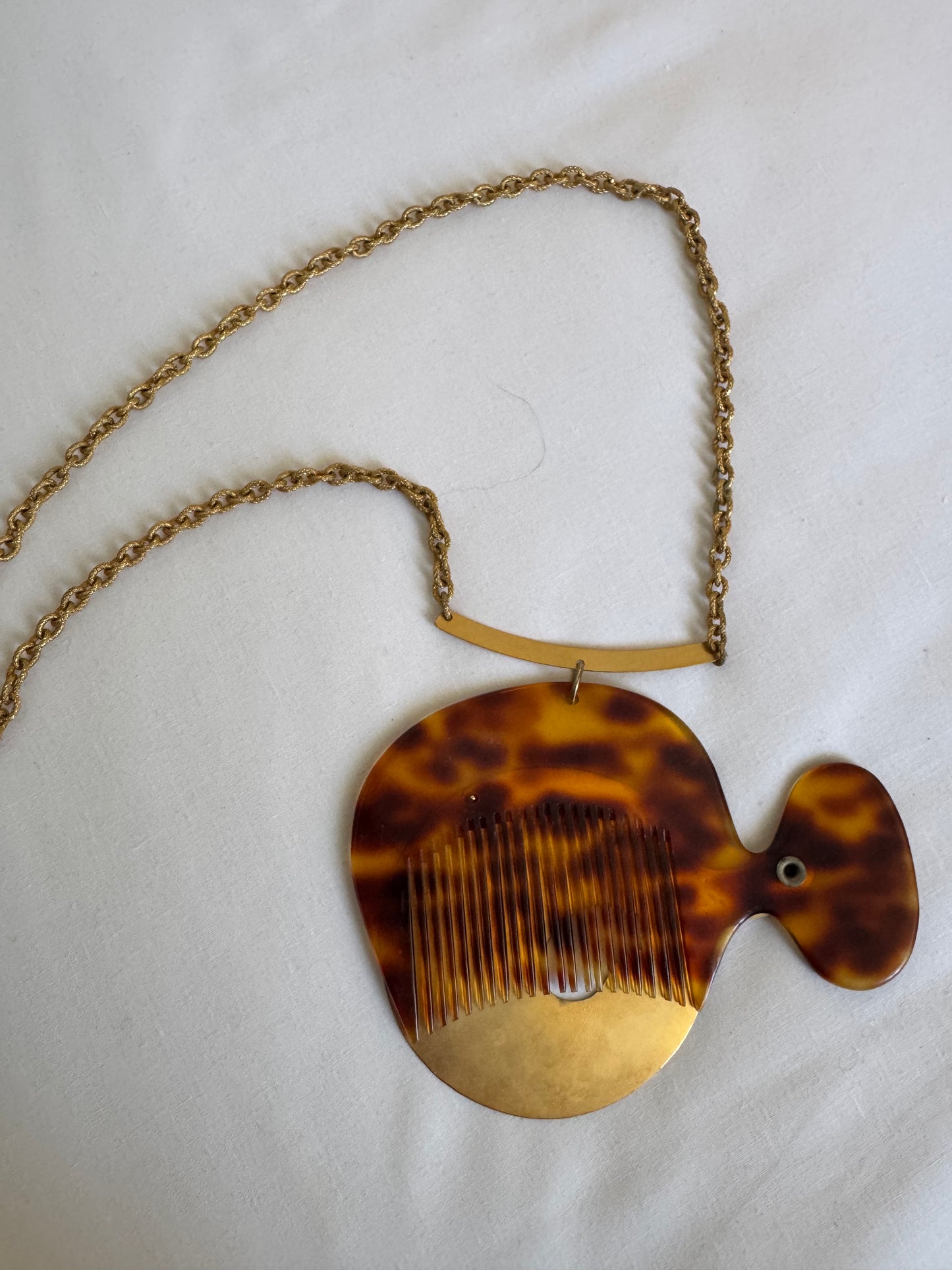 What a wonderful, crazy 1960s vintage piece found at the Paris flea market. It's a necklace with a jumbo tortoise comb and a sculptural gold tone cover. Sourced in Paris.