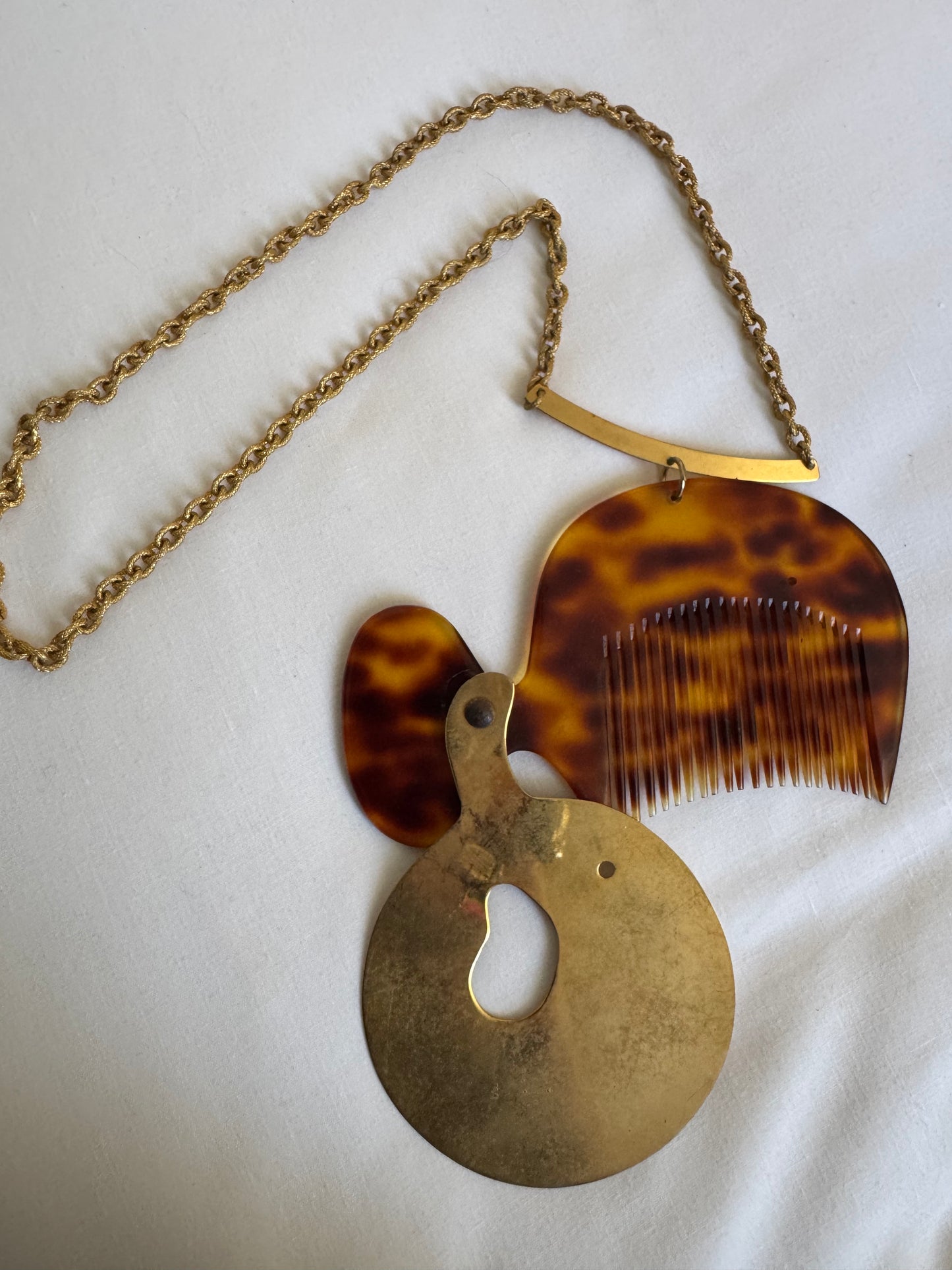 What a wonderful, crazy 1960s vintage piece found at the Paris flea market. It's a necklace with a jumbo tortoise comb and a sculptural gold tone cover. Sourced in Paris.