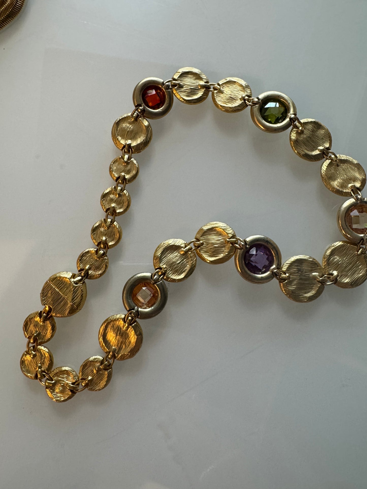 Beautiful 1980s gold tone disc necklace with colorful rhinestones throughout