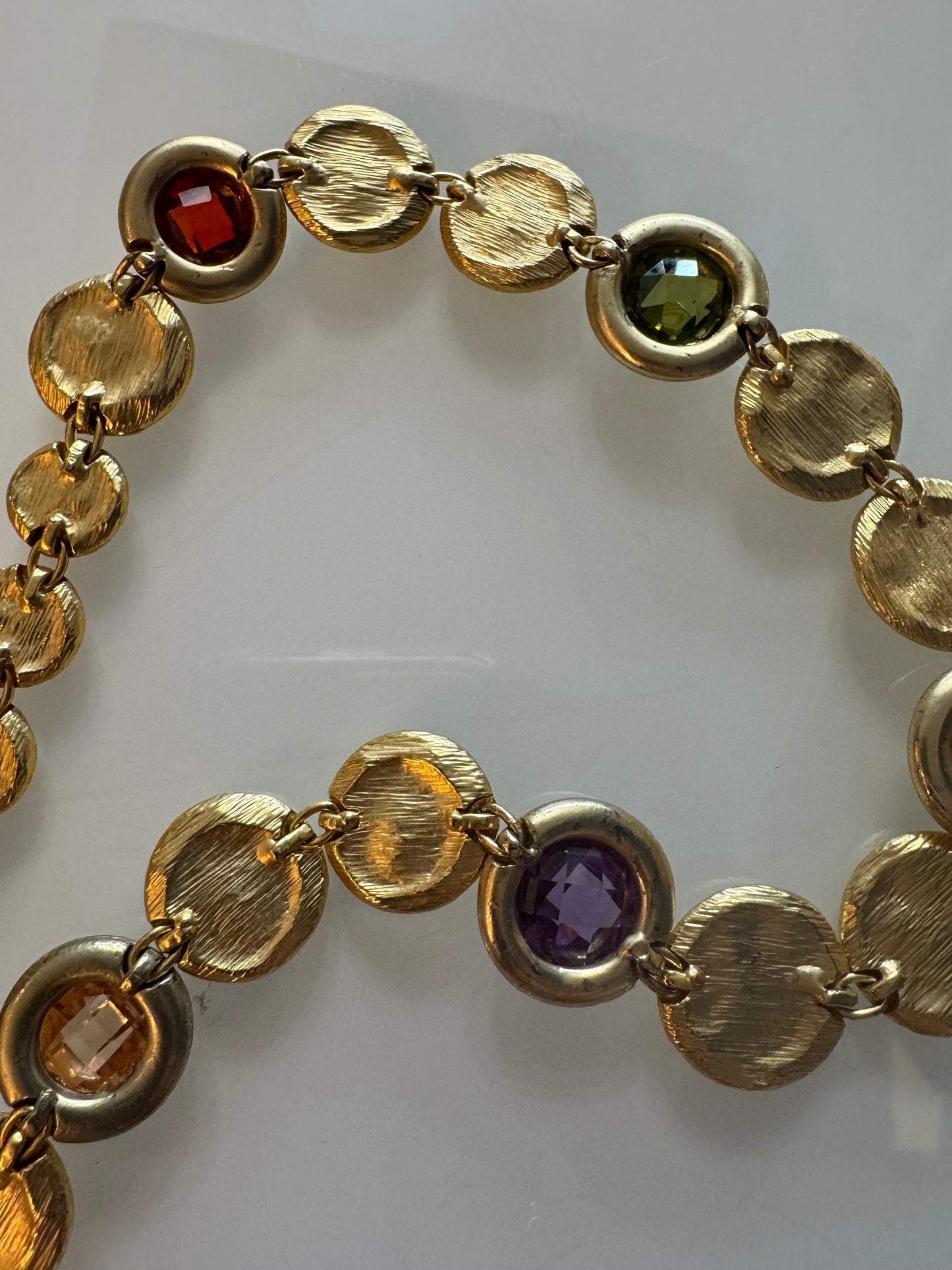 Beautiful 1980s gold tone disc necklace with colorful rhinestones throughout