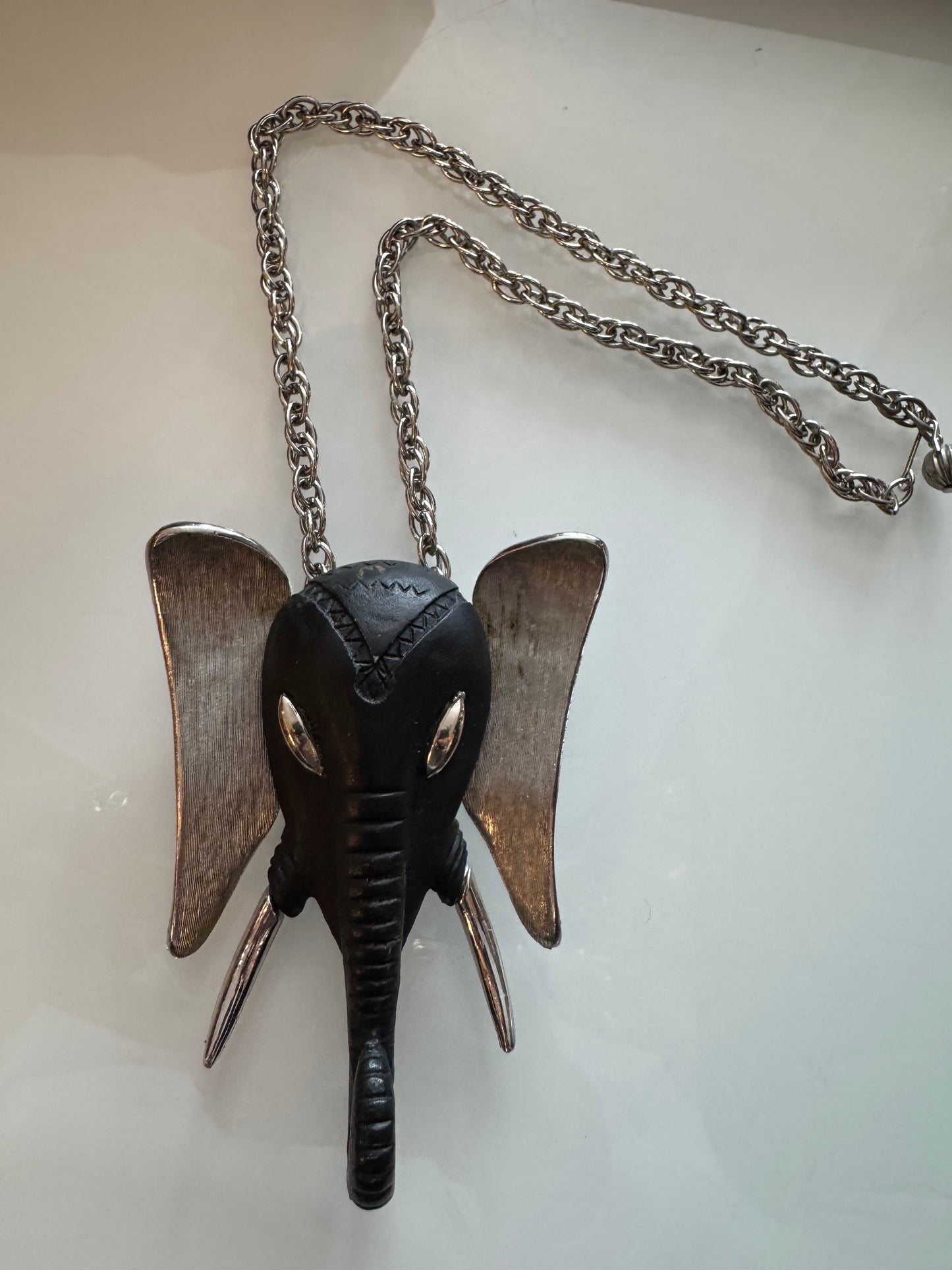 Silver tone and black version of the infamous 1970s elephant head necklace