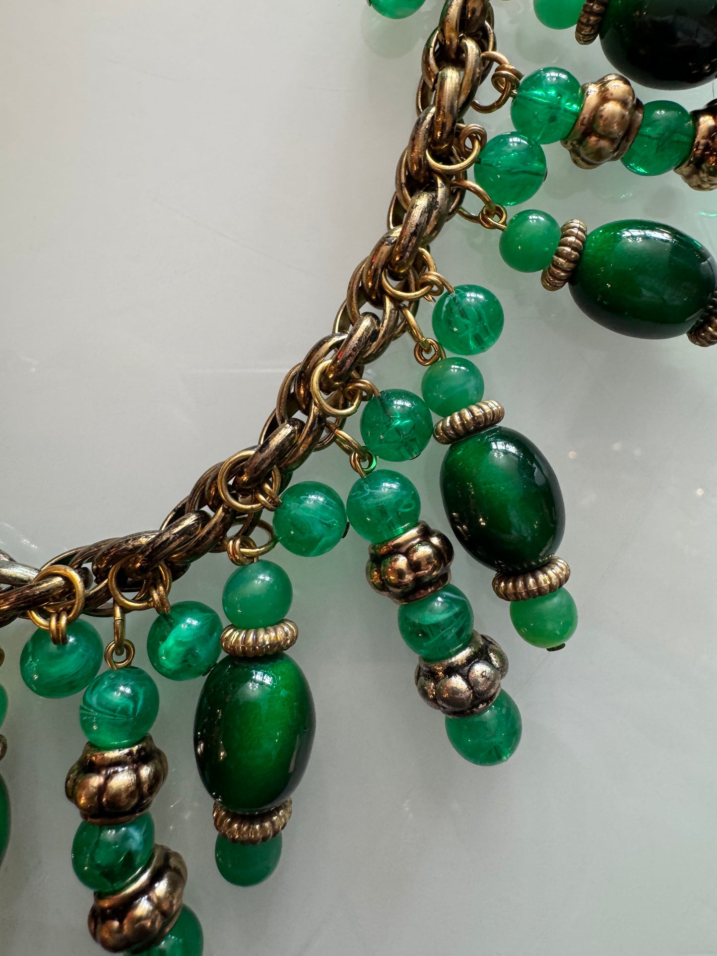 Beautiful vintage statement piece in gold tone with greens dangling stones