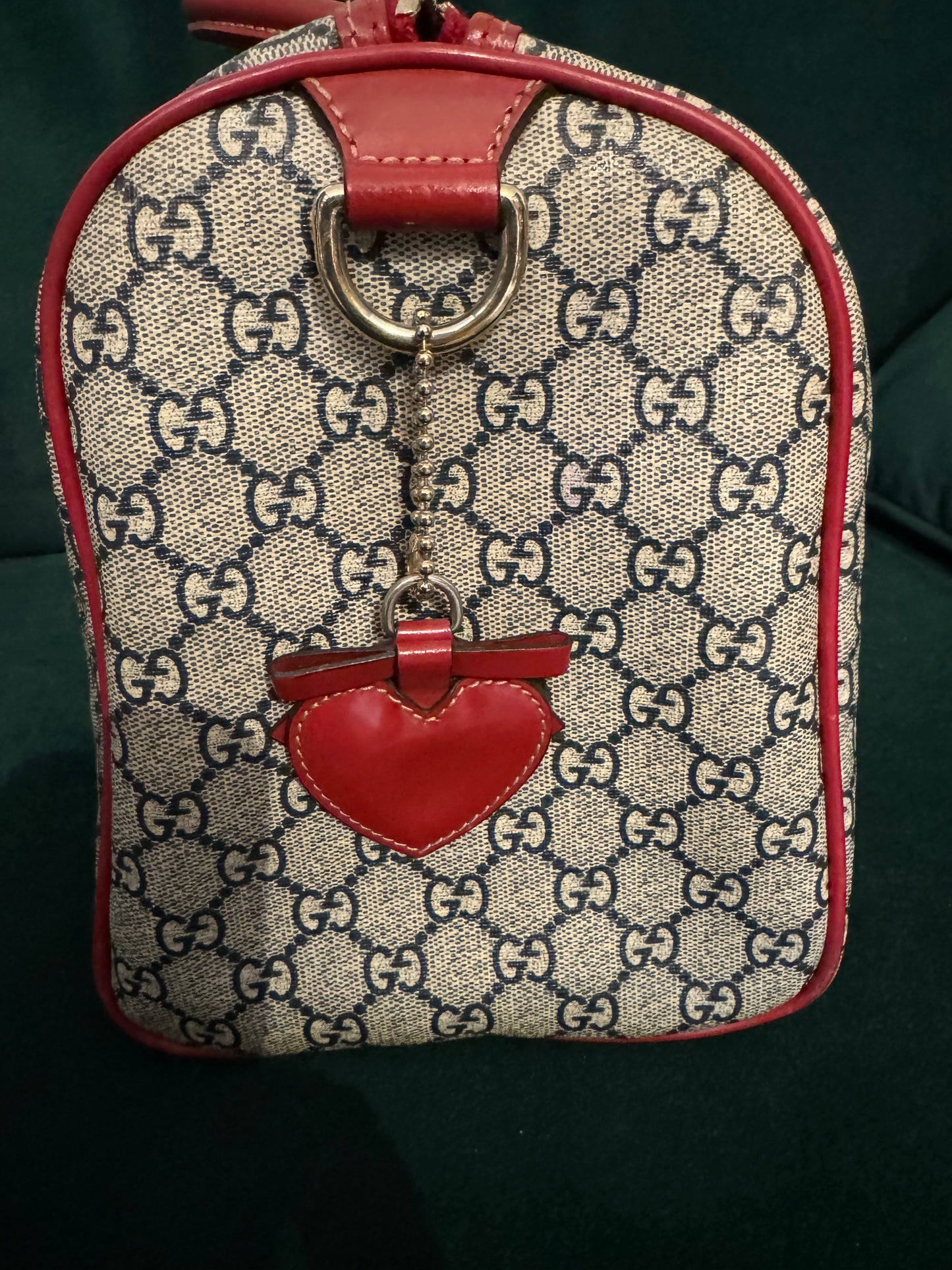 Pre-loved Gucci Boston Joy Tattoo Heart canvas with red leather top handle handbag. Comes with dust bag. Interior needs a little cleaning.