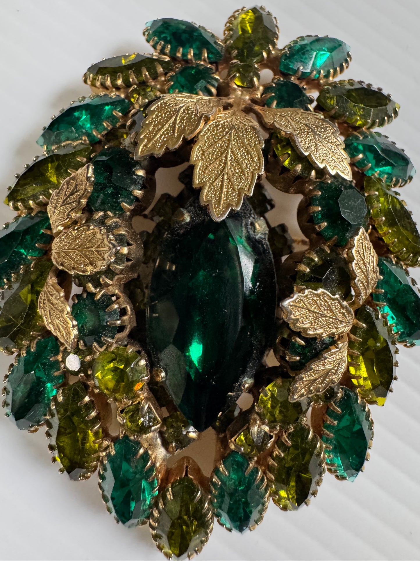 Wonderful jumbo Julianna 1940s brooch/pendant with shades of green rhinestones and gold leaf detail