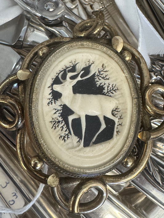 WOW!! A poignant and rare example of 19th-century sentimentality, this antique swivel brooch features a finely molded stag cameo on one side and intricately woven hair on the reverse — both protected under domed glass. Set in a gold-tone scrollwork frame,