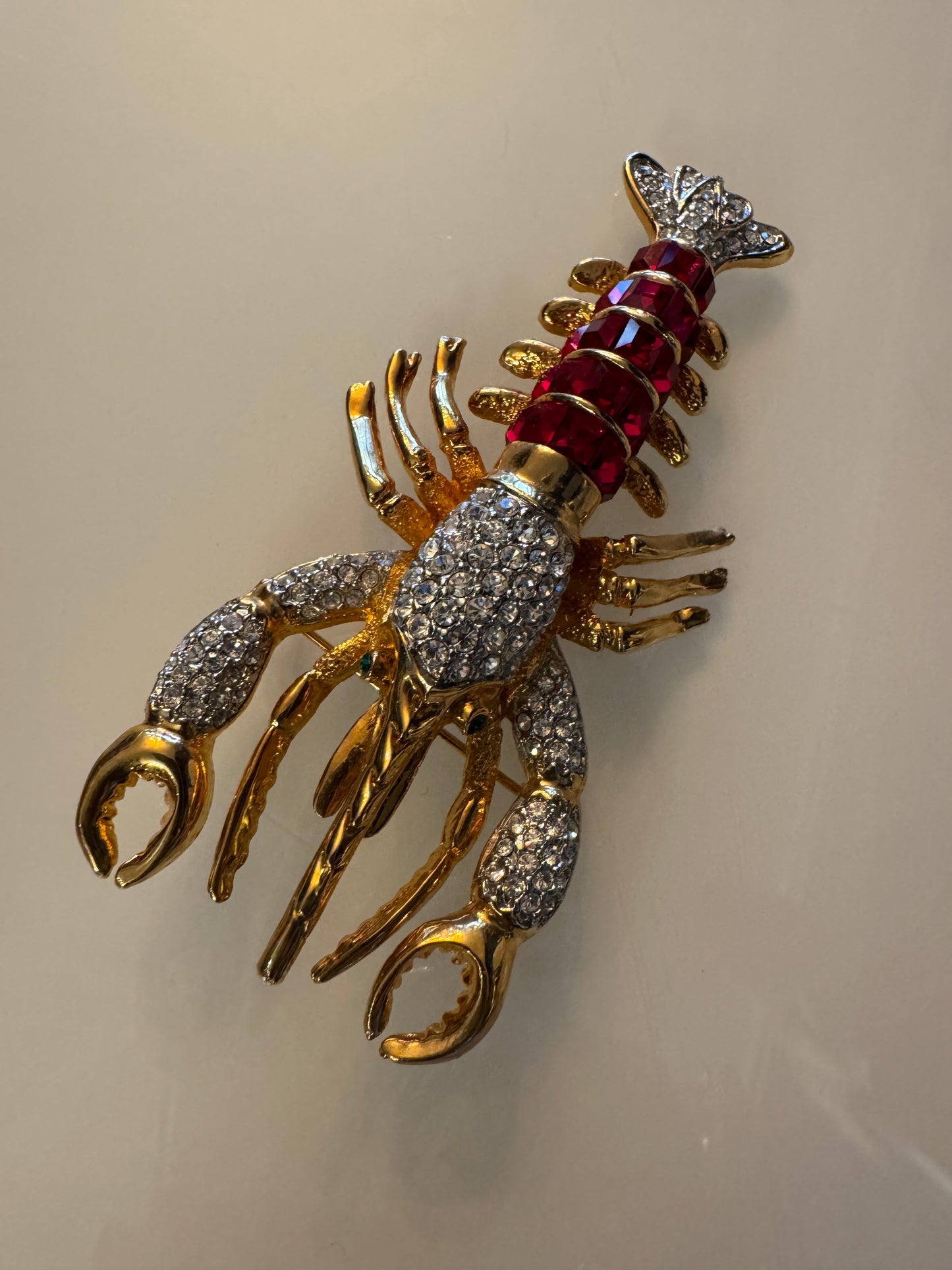 Vintage 1980s lobster brooch with red stones and green eyes and rhinestone body