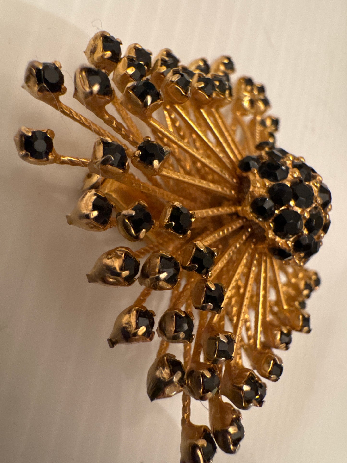 Jet black starburst spoke signed WARNER brooch