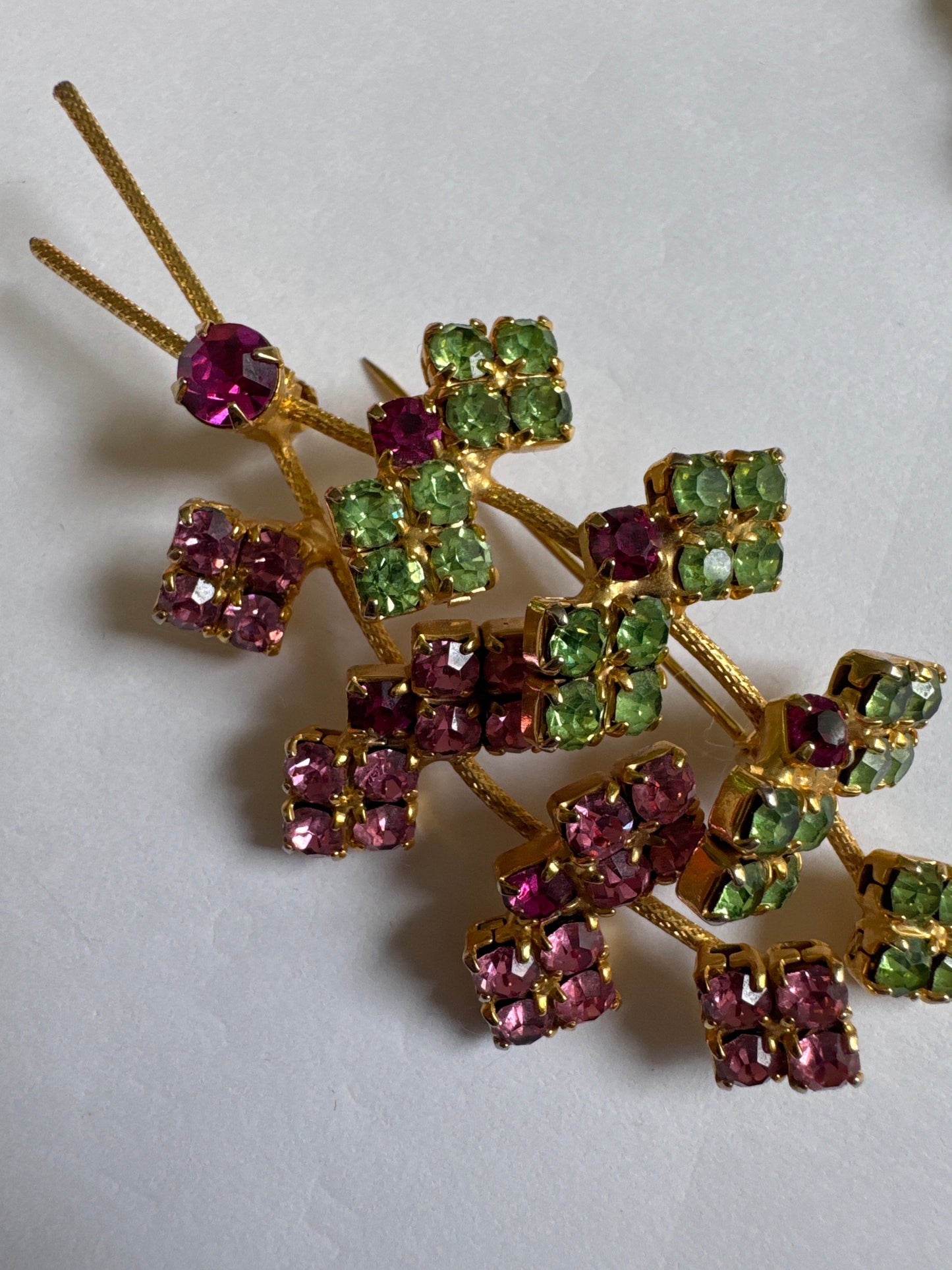 Beautiful mid-century, floral spray, brooch featuring pink and green rhinestones on a gold tone back