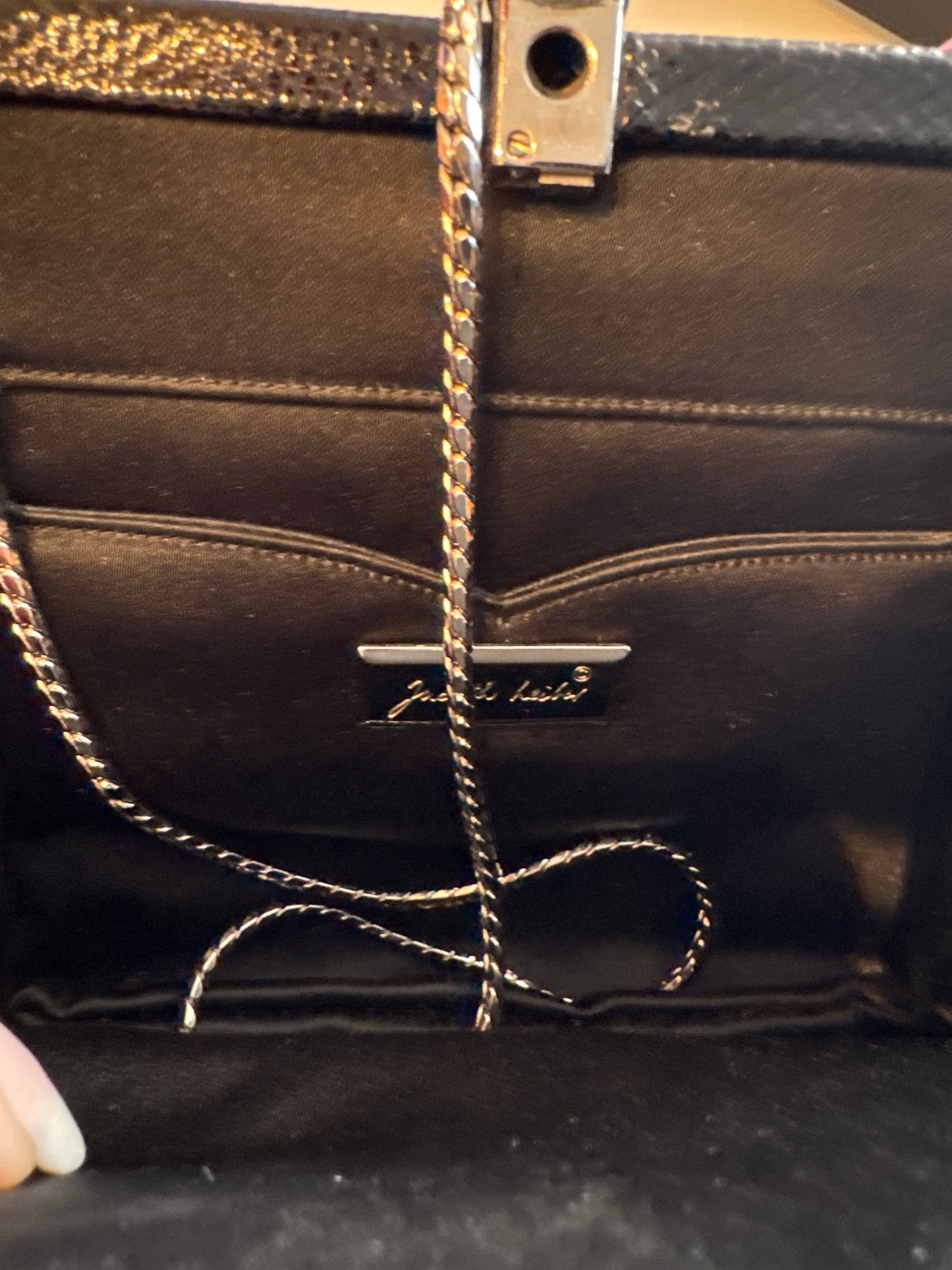 1980s gorgeous Black Judith Lieber with Art Deco, inspired and crusted jewels, including black and pink enamel and rhinestone detail. Silver attached shoulder chain.