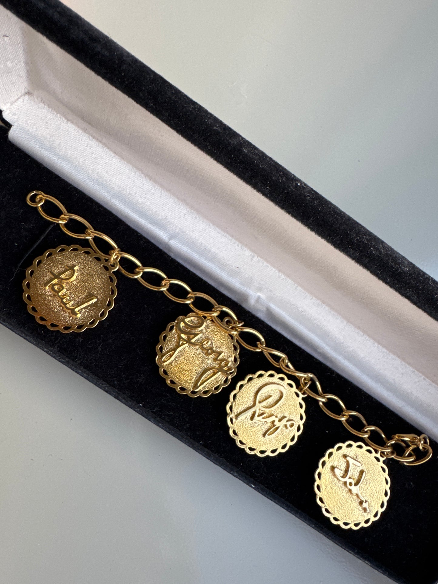 Amazing 1970s charm bracelet featuring pictures of the Beatles, Paul, George Ringo, and John with their names on the back of each charm. Tom