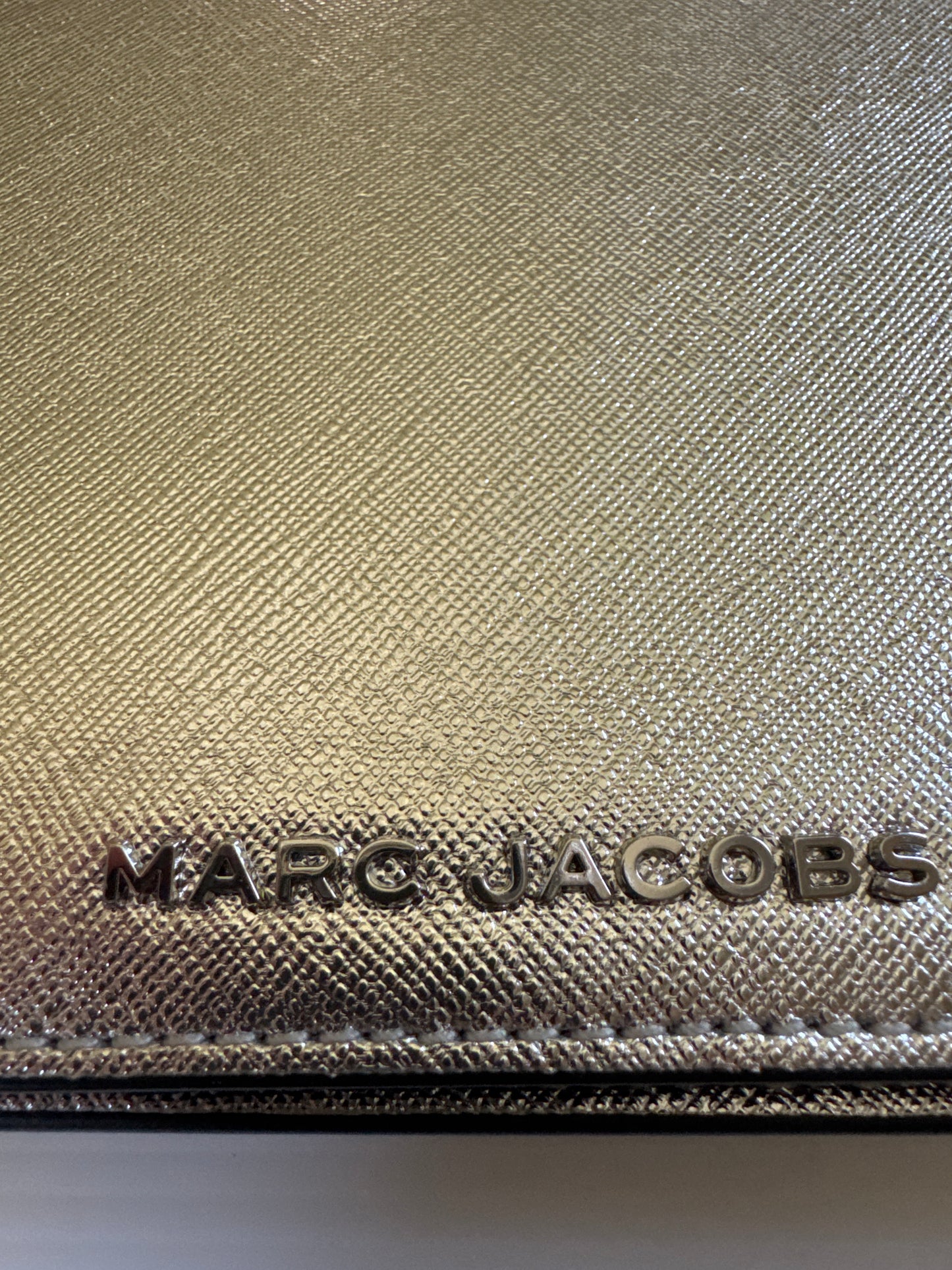 Never worn 1990s Marc Jacob's silver leather clutch with optional strap. Zippered interior and credit card slots plus a small back pocket.