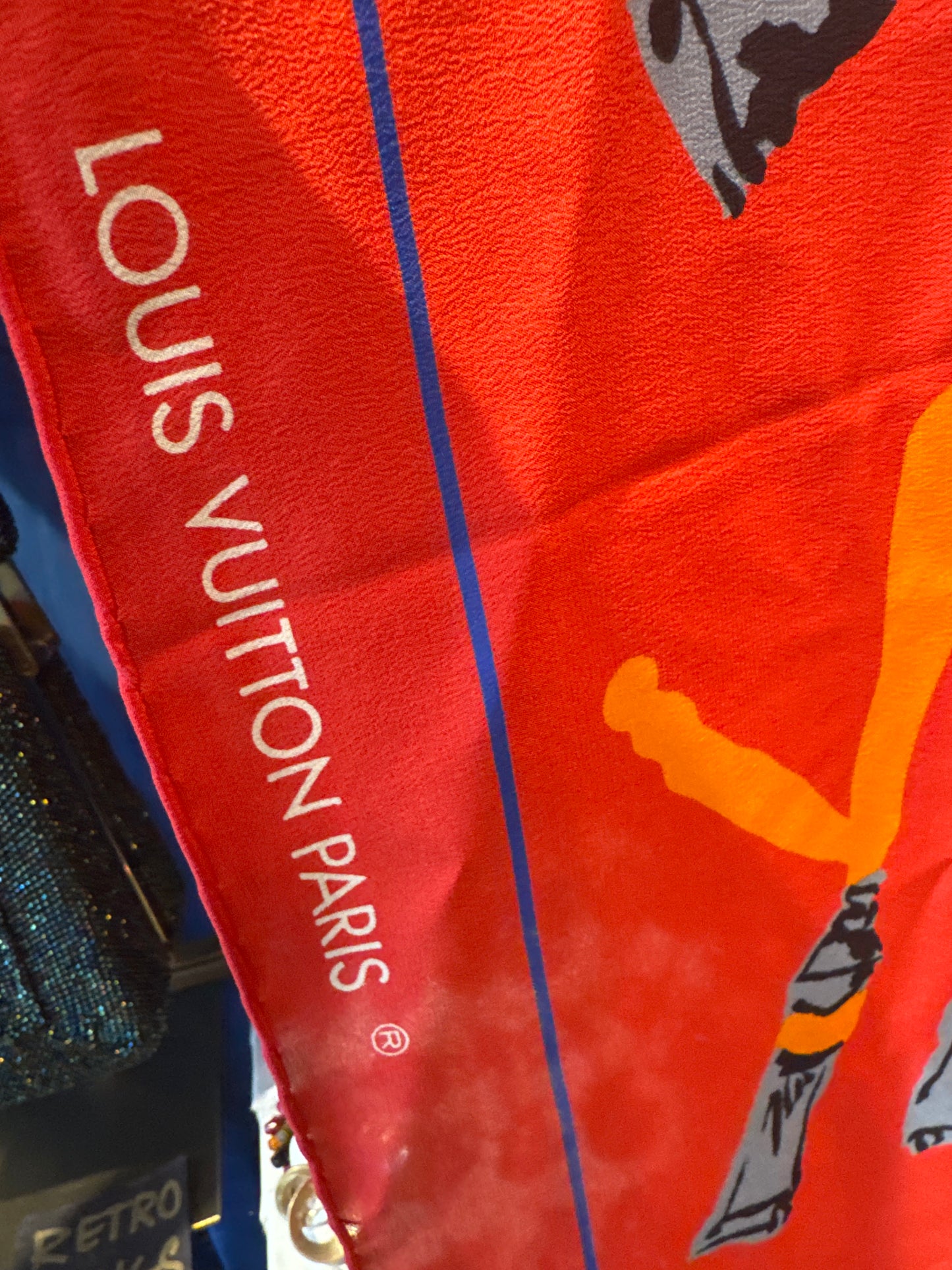Vintage early 1990s Louis Vuitton red voyage silk scarf. Louis Vuitton “Le Temps d’un Voyage” scarf  is by Italian designer/architect Gae Aulenti, with scattered paint tubes with graffiti-style lettering and hand rolled edges.