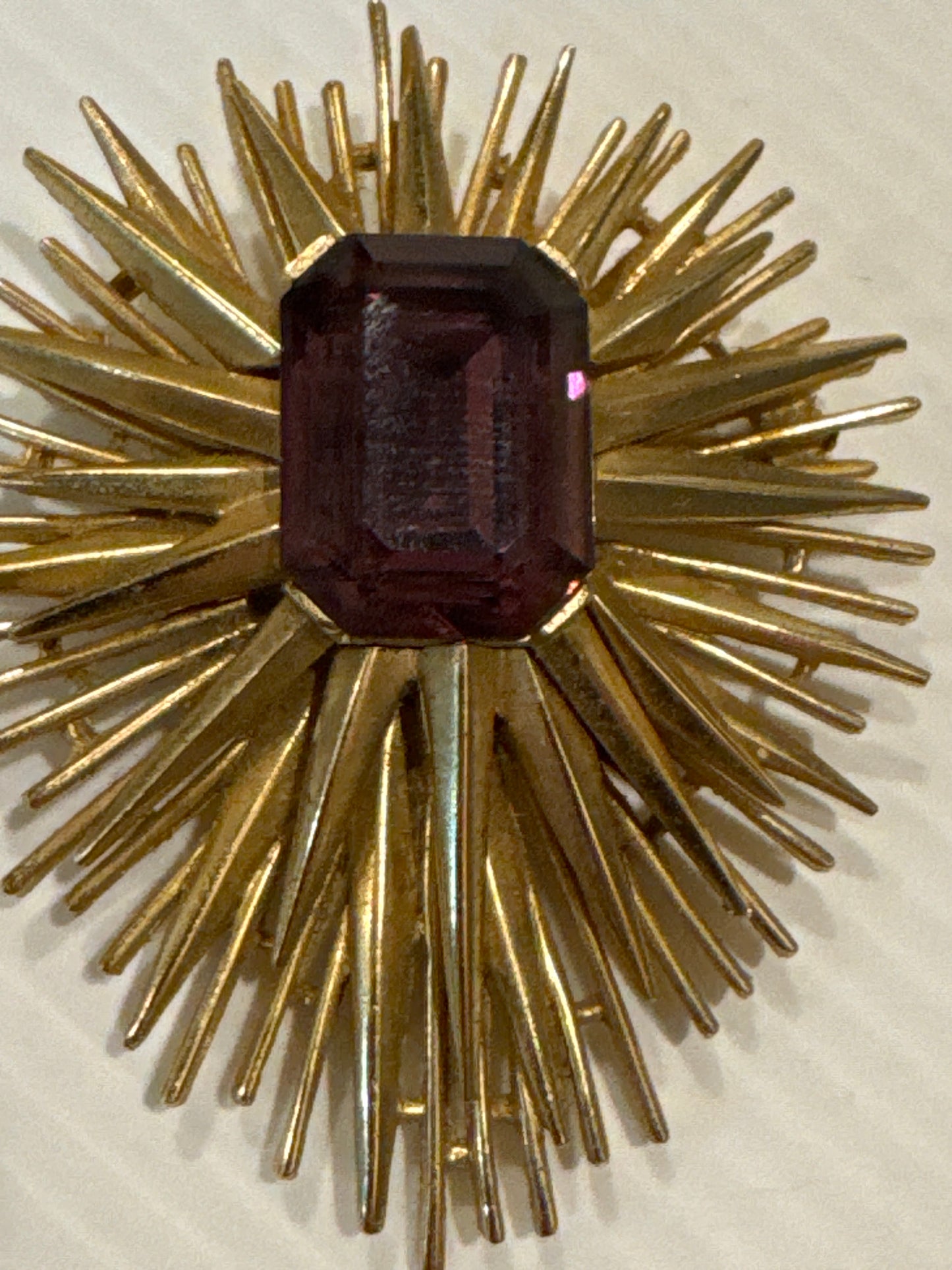 Beautiful signed Trifari Starburst brooch with emerald cut amethyst stone