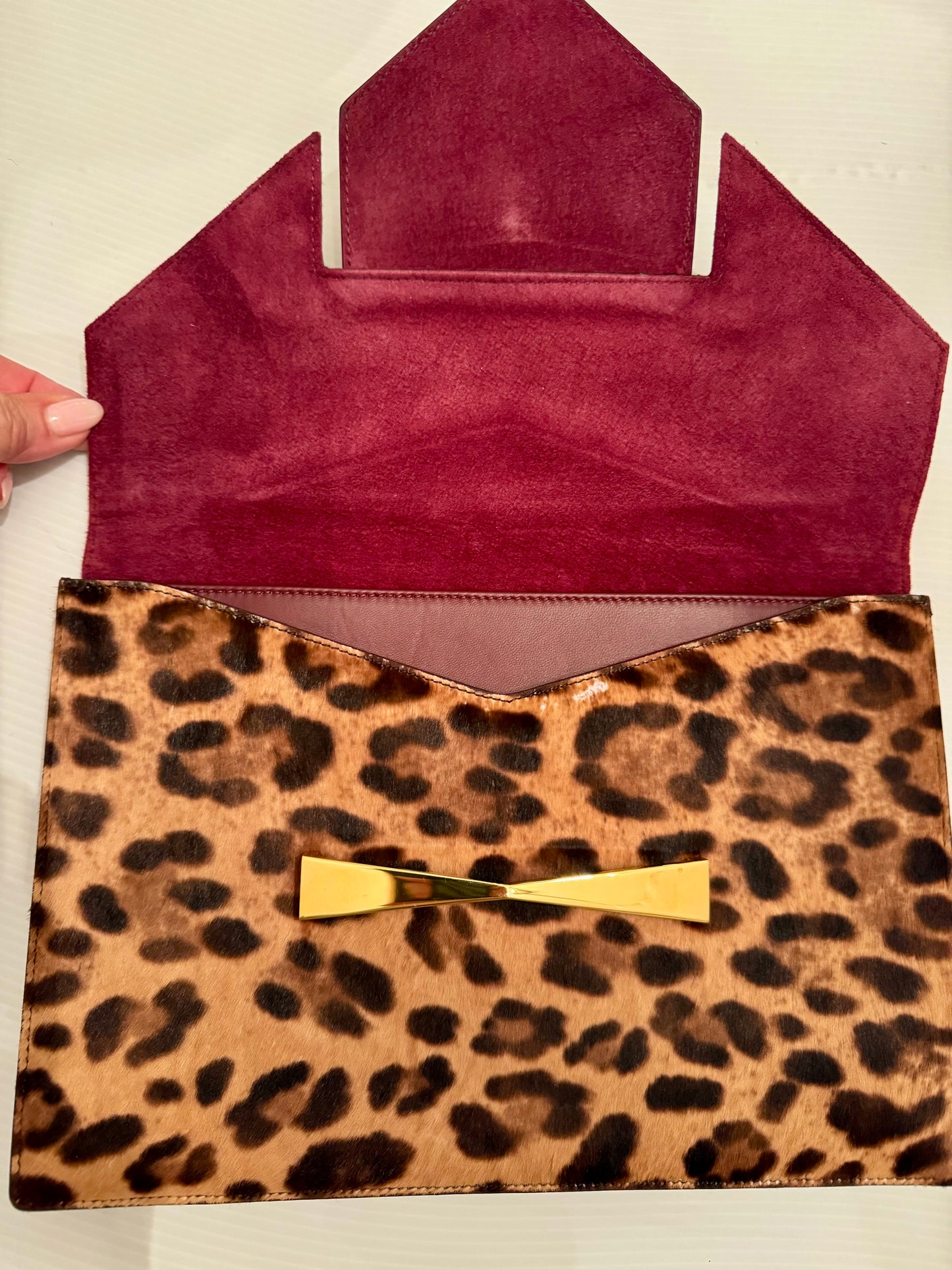 Alexander McQueen pony hair clutch with gold hardware, burgundy suede interior and gold hardware