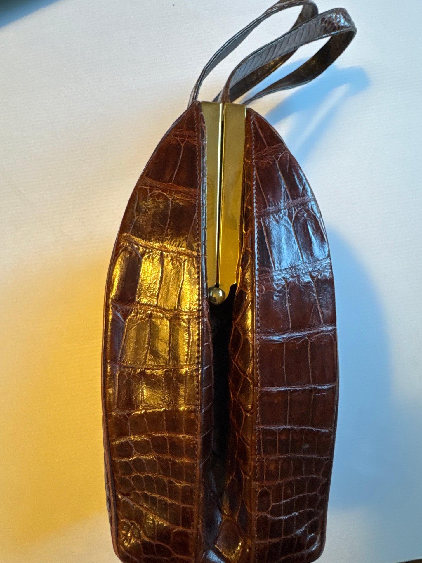 Vintage 50s Deitsch brown alligator double handle handbag. lined in a brown leather with  pockets on both sides and comes with a mirror, comb and attached coin purse.