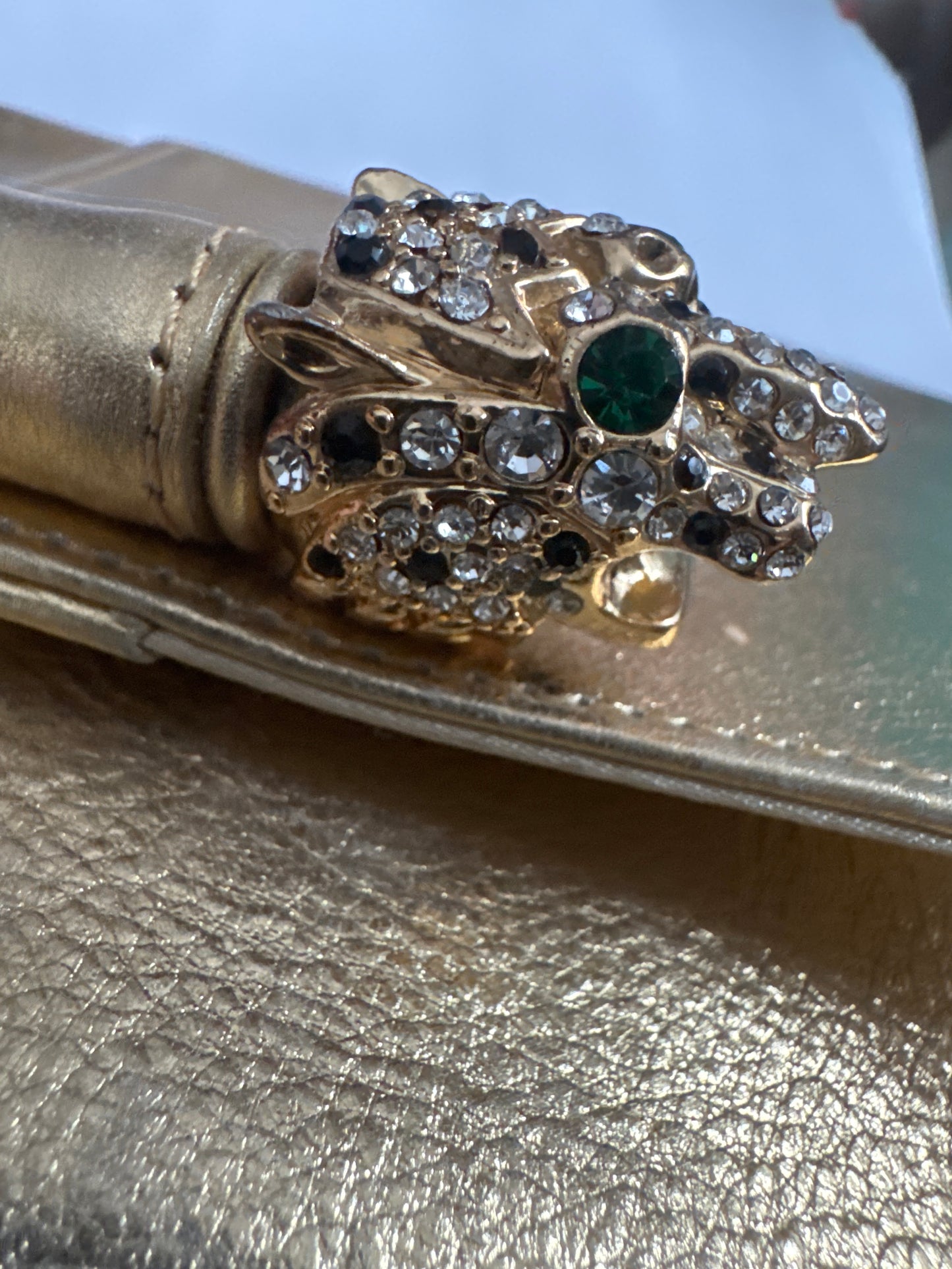 Beautiful 1970s signed Kenneth J Lane gold lambskin convertible clutch with two rhinestone tiger eyes