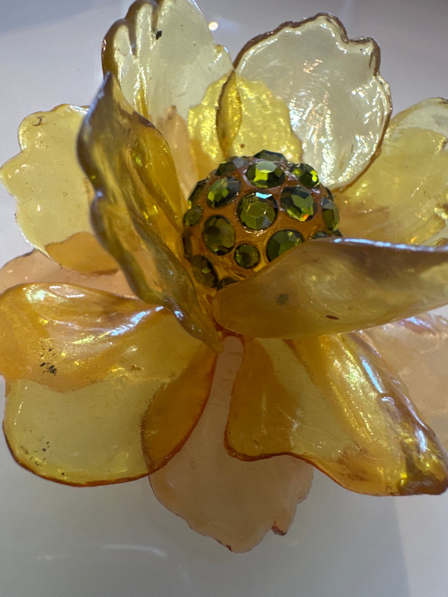 1960s 3-D yellow lucite brooch with green center rhinestones