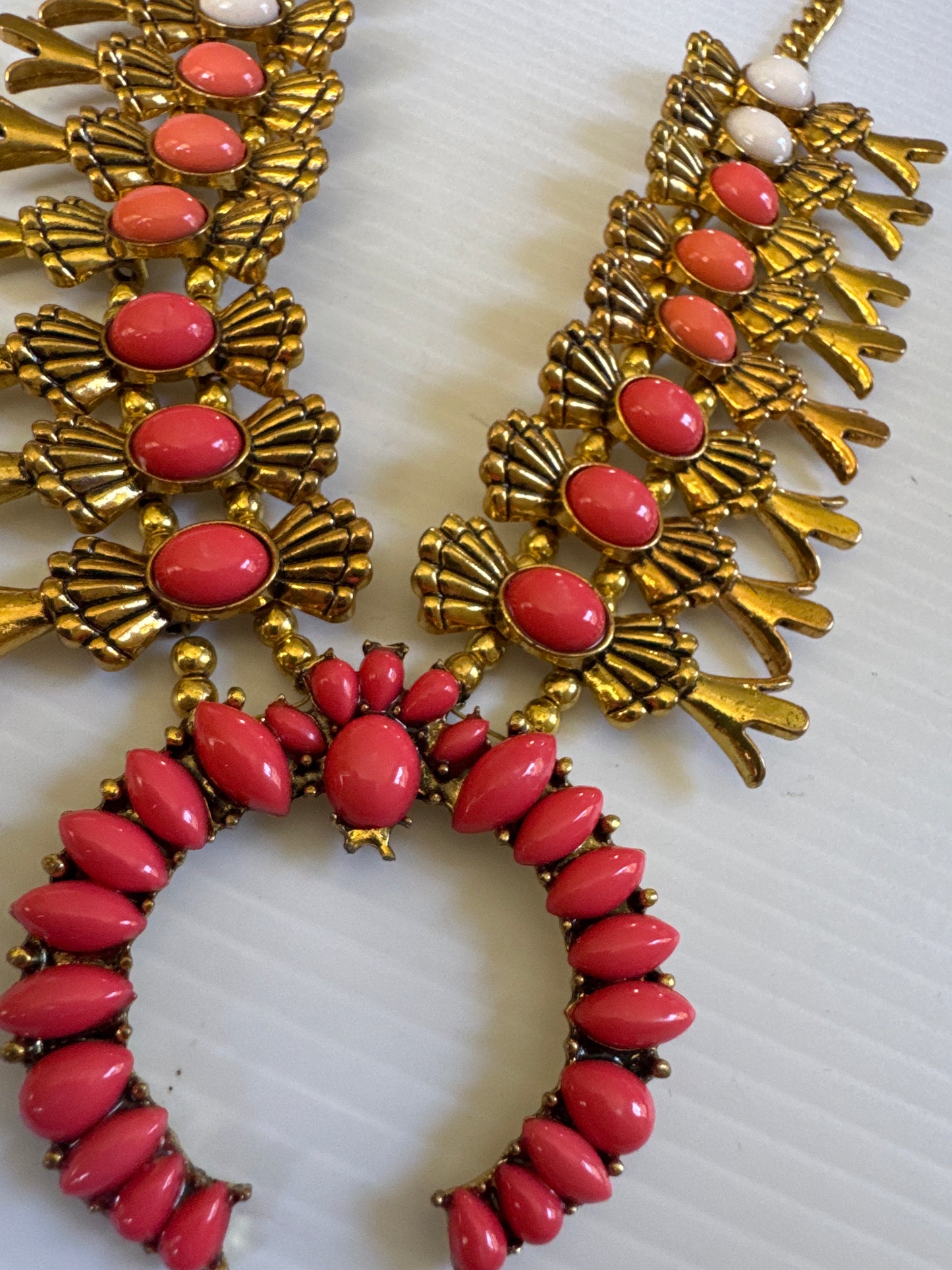 1990s adjustable squash blossom necklace in a gold tone setting with shades of coral stones