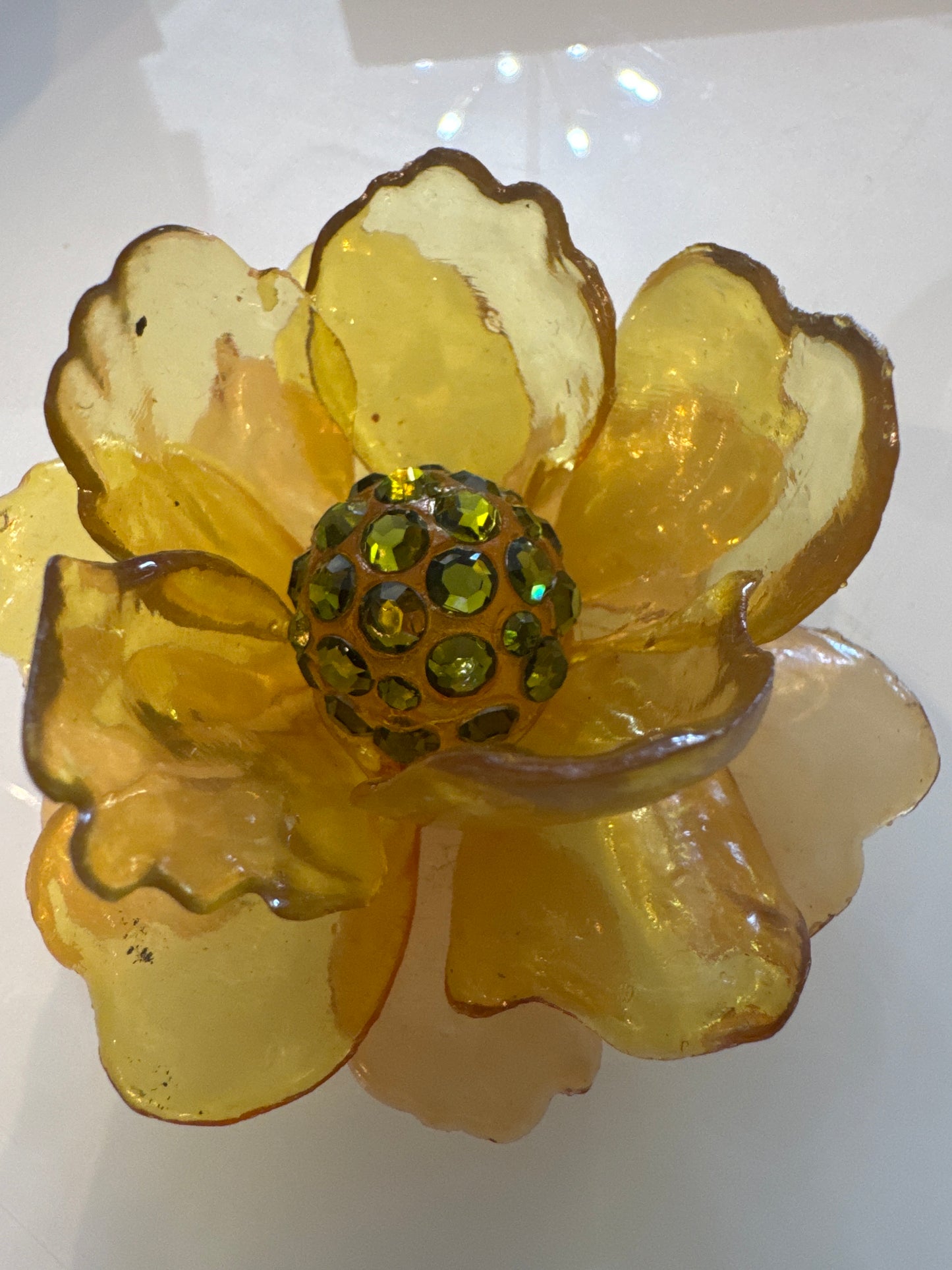 1960s 3-D yellow lucite brooch with green center rhinestones