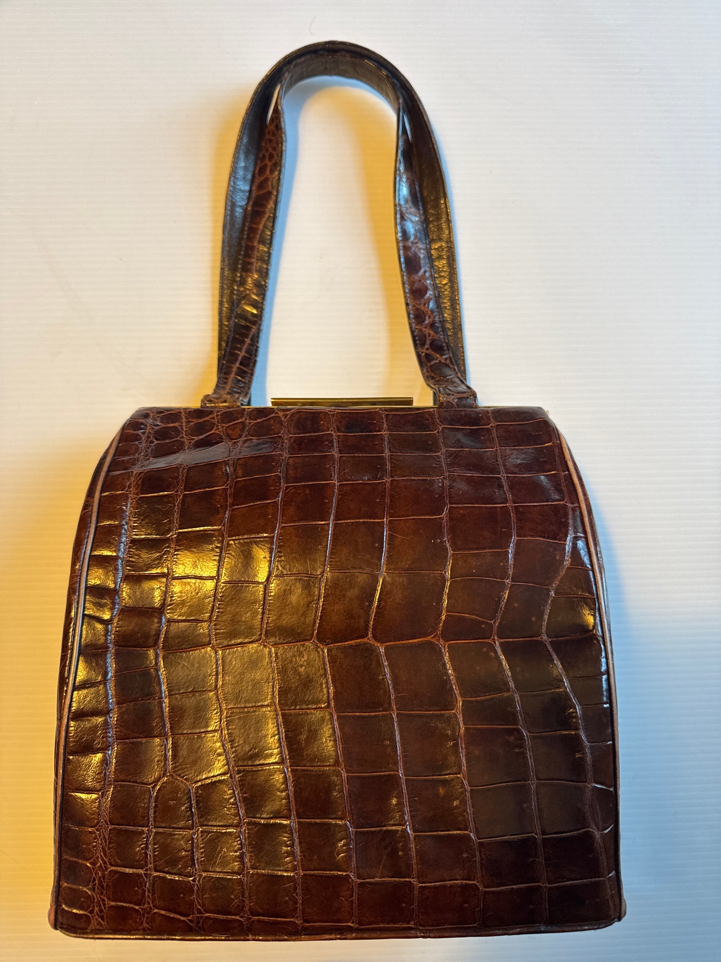 Vintage 50s Deitsch brown alligator double handle handbag. lined in a brown leather with  pockets on both sides and comes with a mirror, comb and attached coin purse.