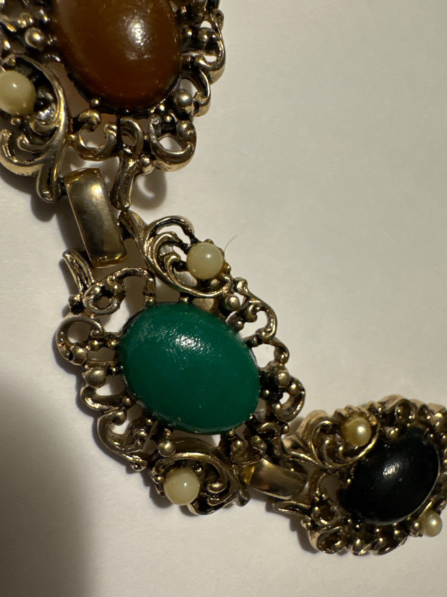 1970s gold tone bracelet with colored cabochons and faux pearls. Road