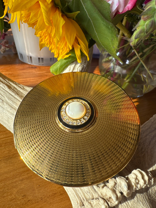 Beautiful signed STRATTON England, gold tone make up compact with black enamel rhinestone and white cabachon stone