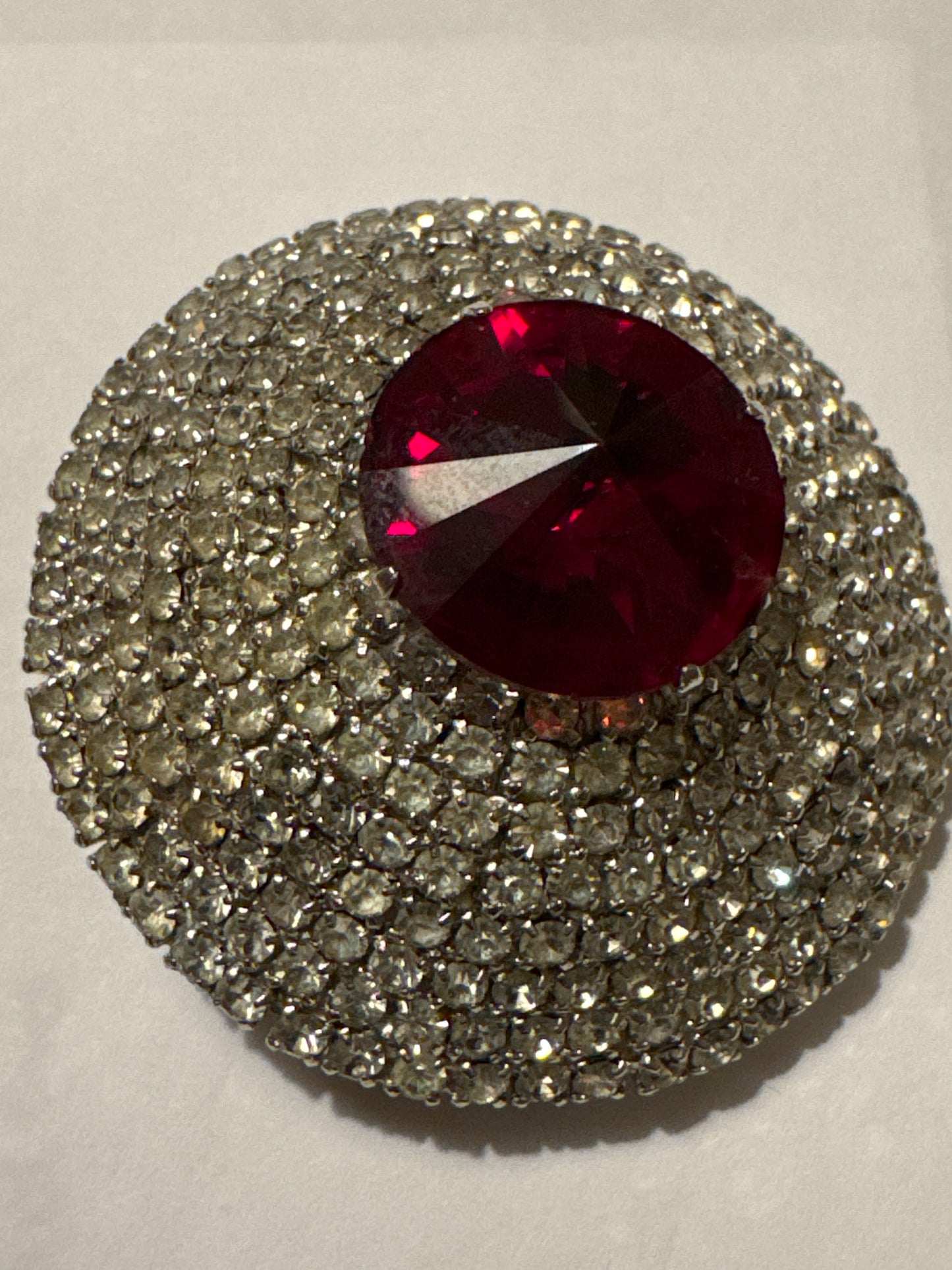mid 1950s signed Hattie Carnegie pave dome brooch with Ruby red glass center, stone and hundreds of individually set pronged rhinestones