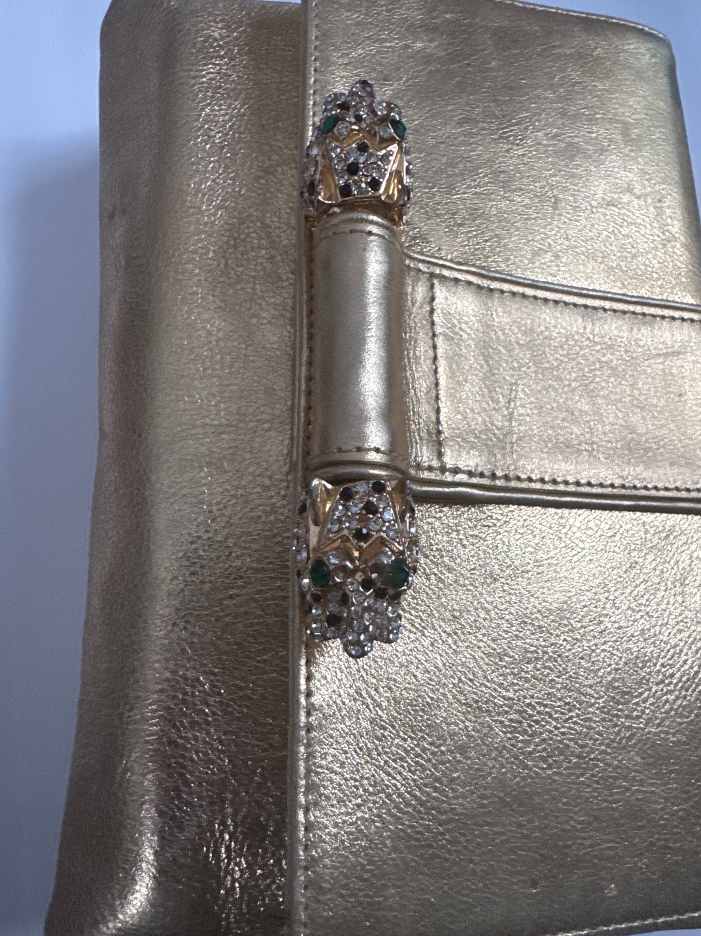 Beautiful 1970s signed Kenneth J Lane gold lambskin convertible clutch with two rhinestone tiger eyes