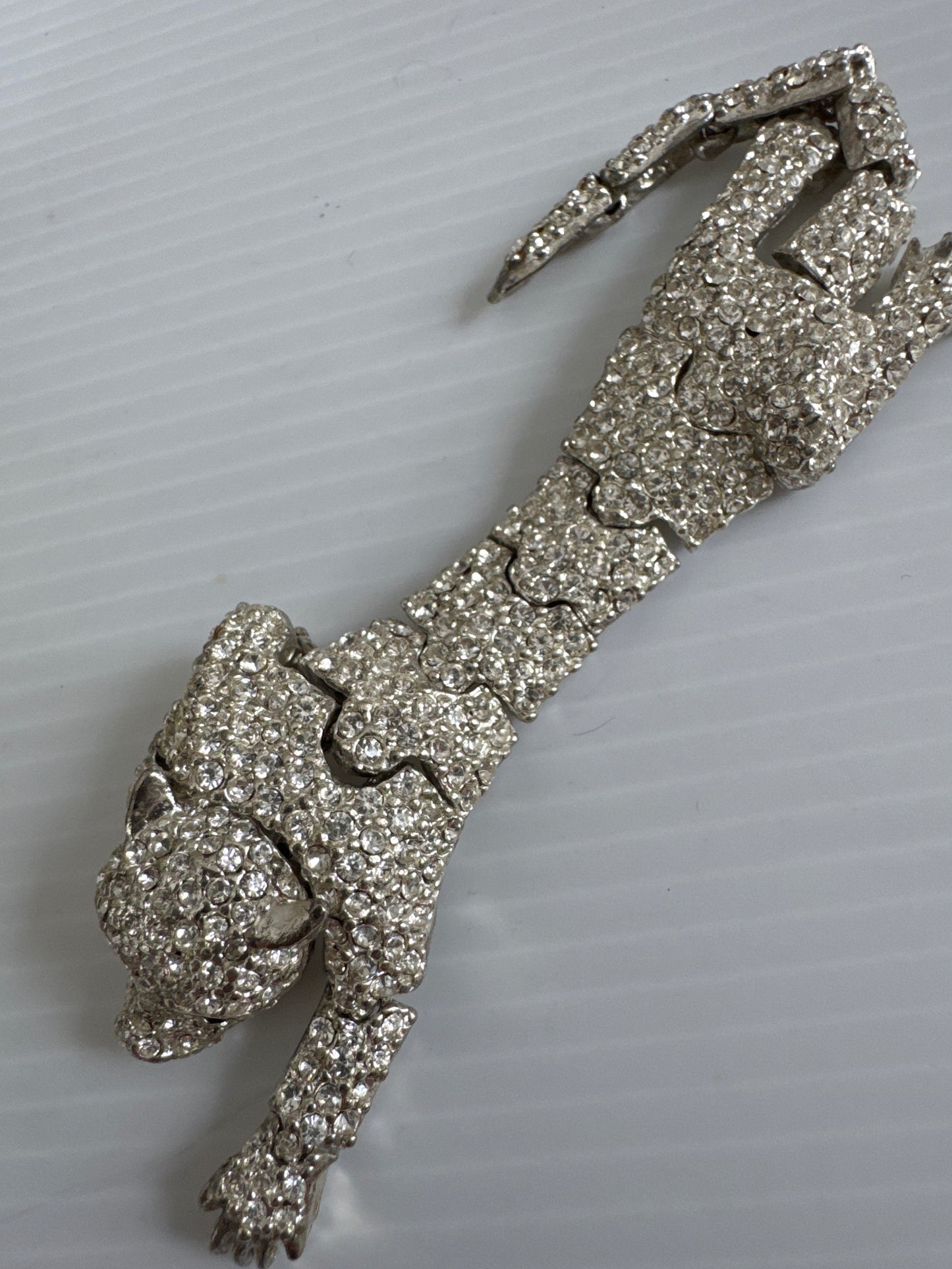 1950s beautiful crystal rhinestone articulated cheetah shoulder brooch with green emerald colored eyes