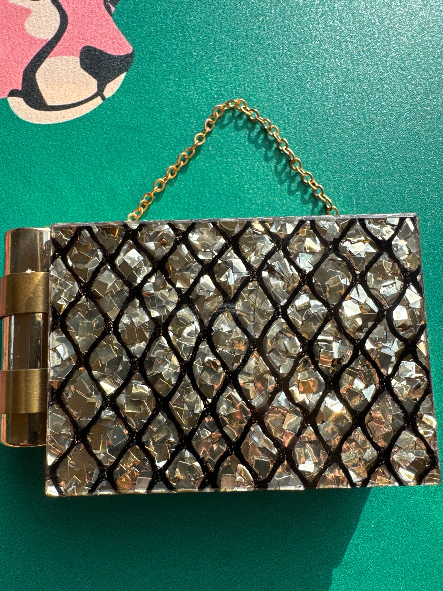Stunning 1940s minaudiere with a dramatic shattered lucite confetti design. This bag carries a lipstick, powder, mirror, coins.