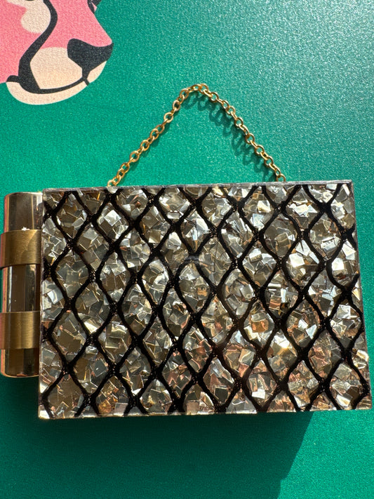 Stunning 1940s minaudiere with a dramatic shattered lucite confetti design. This bag carries a lipstick, powder, mirror, coins.