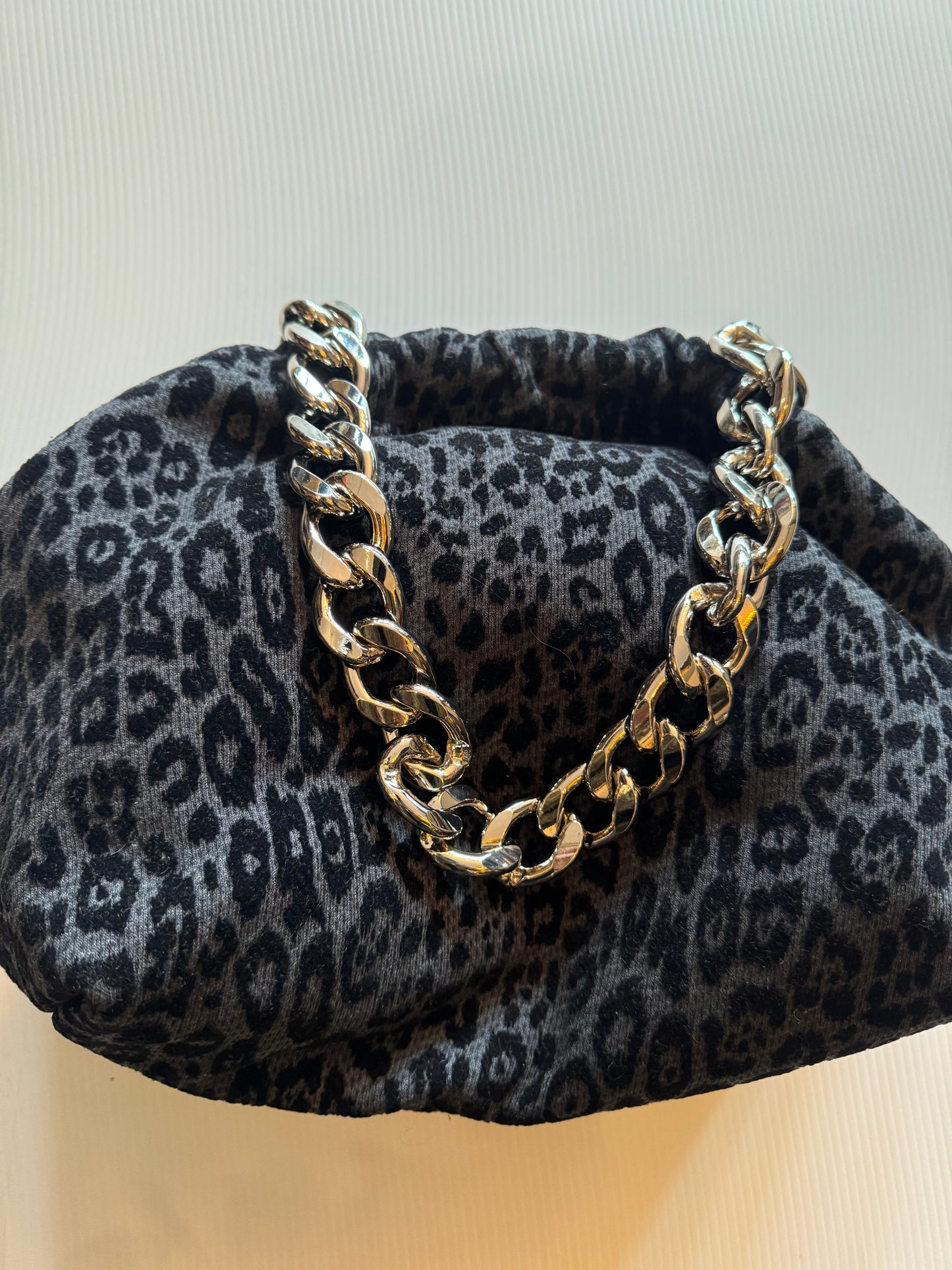 Exclusive Limited Edition Vavra New York bag collection. This burn out velvet leopard print grey and black converts from clutch to shoulder strap with chunky chain shown. Black lining with interior pocket.