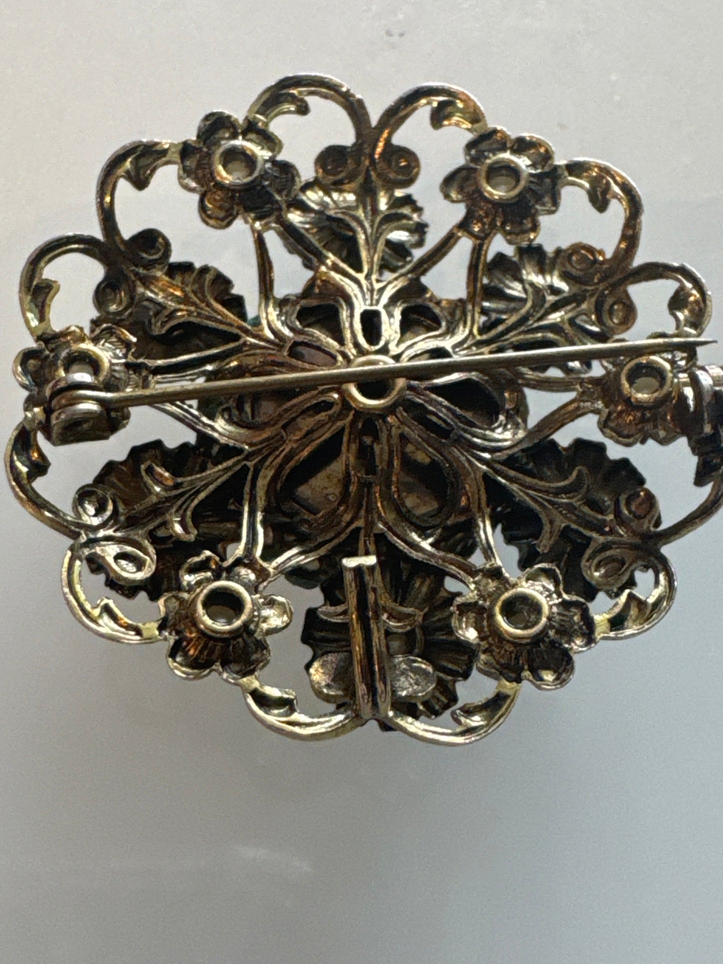 Pearl and gold tone, circular flower pendant / brooch with filigree backing.