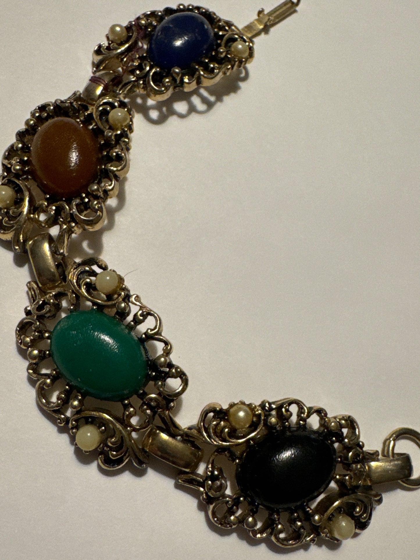 1970s gold tone bracelet with colored cabochons and faux pearls. Road
